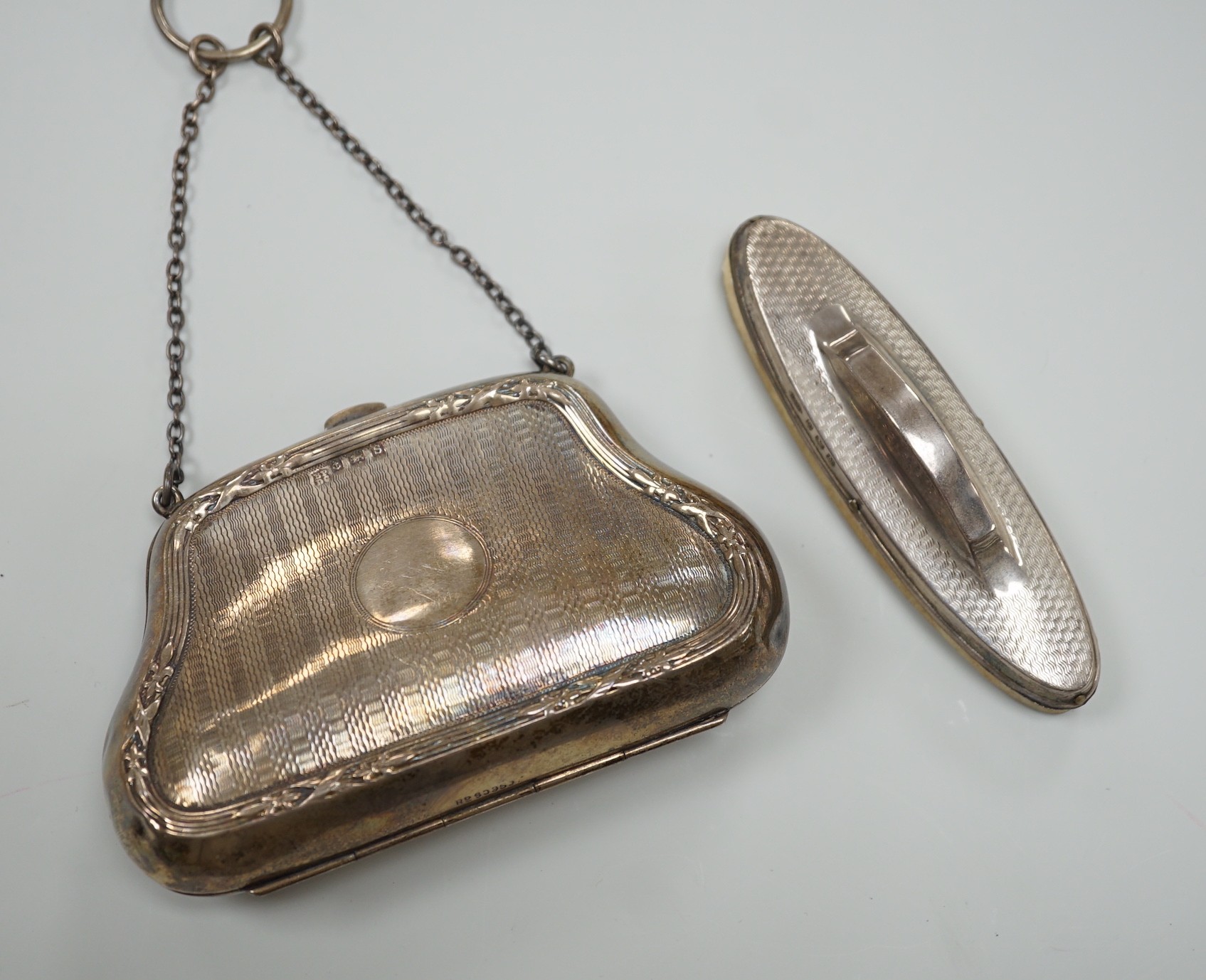 A George V engine turned silver purse, Boots Pure Drug Company, Birmingham, 1917 and a silver mounted nail buffer.                                                                                                          