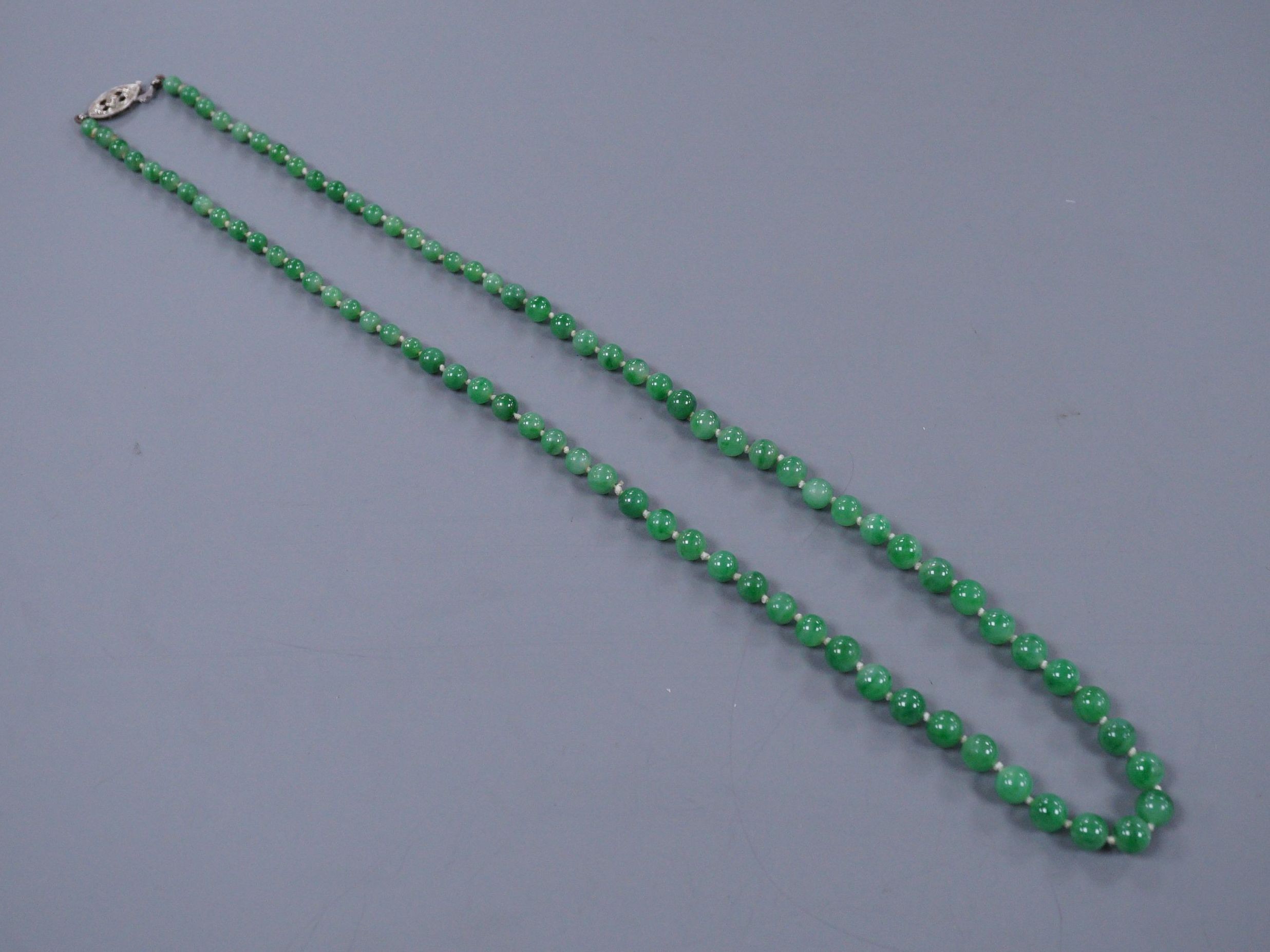 A graduated jade bead necklace with diamond set clasp stamped 9ct, 50cm                                                                                                                                                     