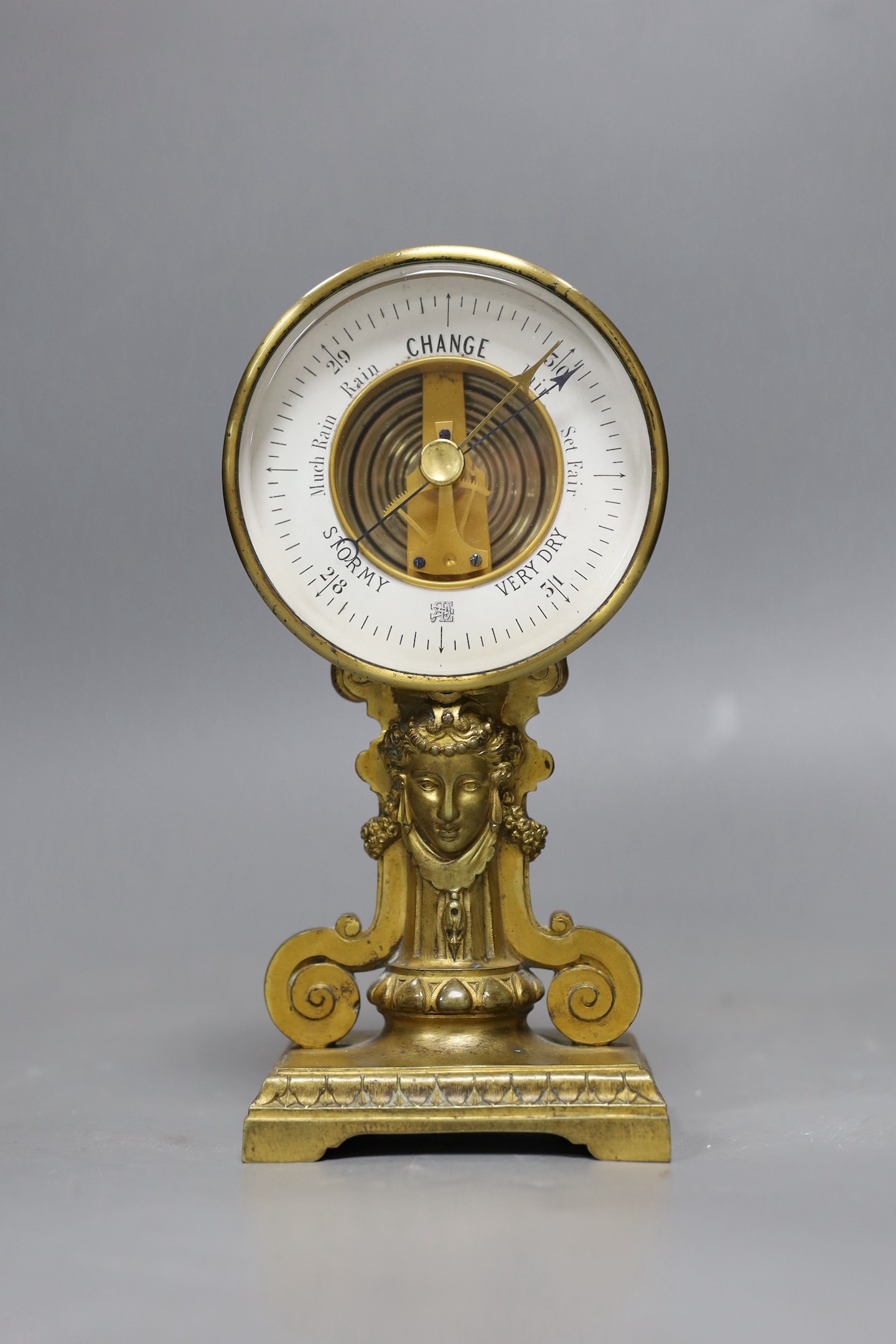 A gilt metal aneroid barometer classical design, 19cms high                                                                                                                                                                 