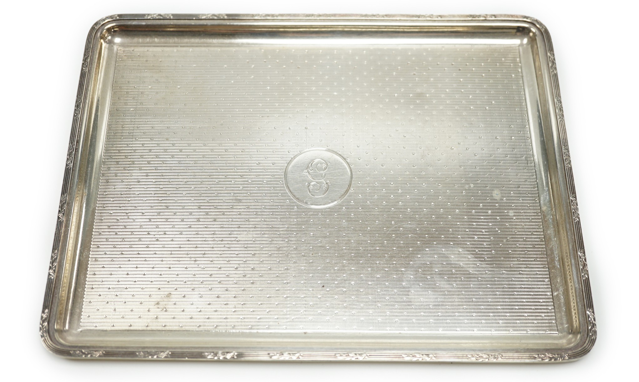 A George V engine turned silver dressing table tray, by Mappin & Webb, London 1915, 27.5cm, 15.3oz.                                                                                                                         