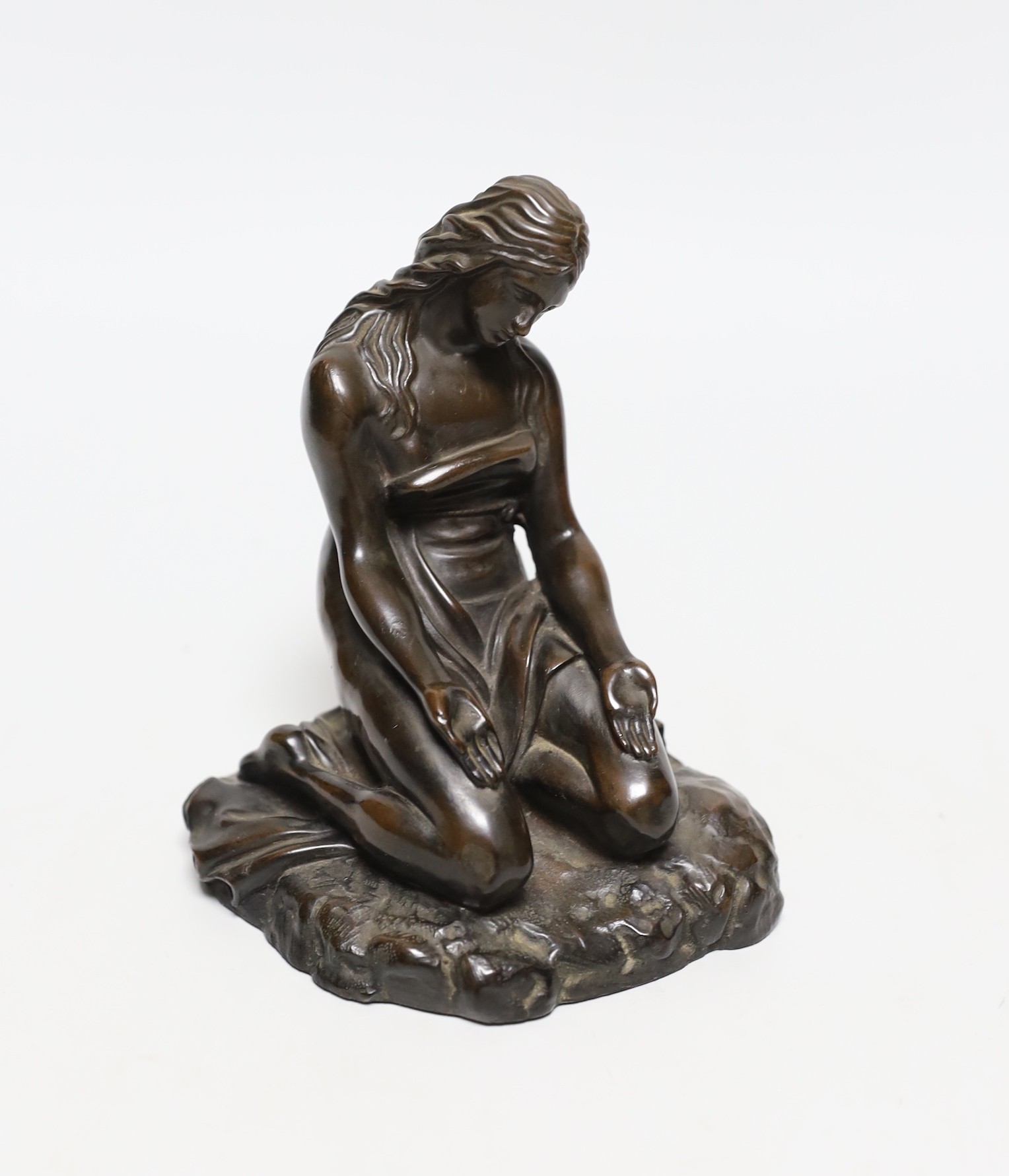 A cast resin figure of a kneeling classical figure, 13.5cms high                                                                                                                                                            