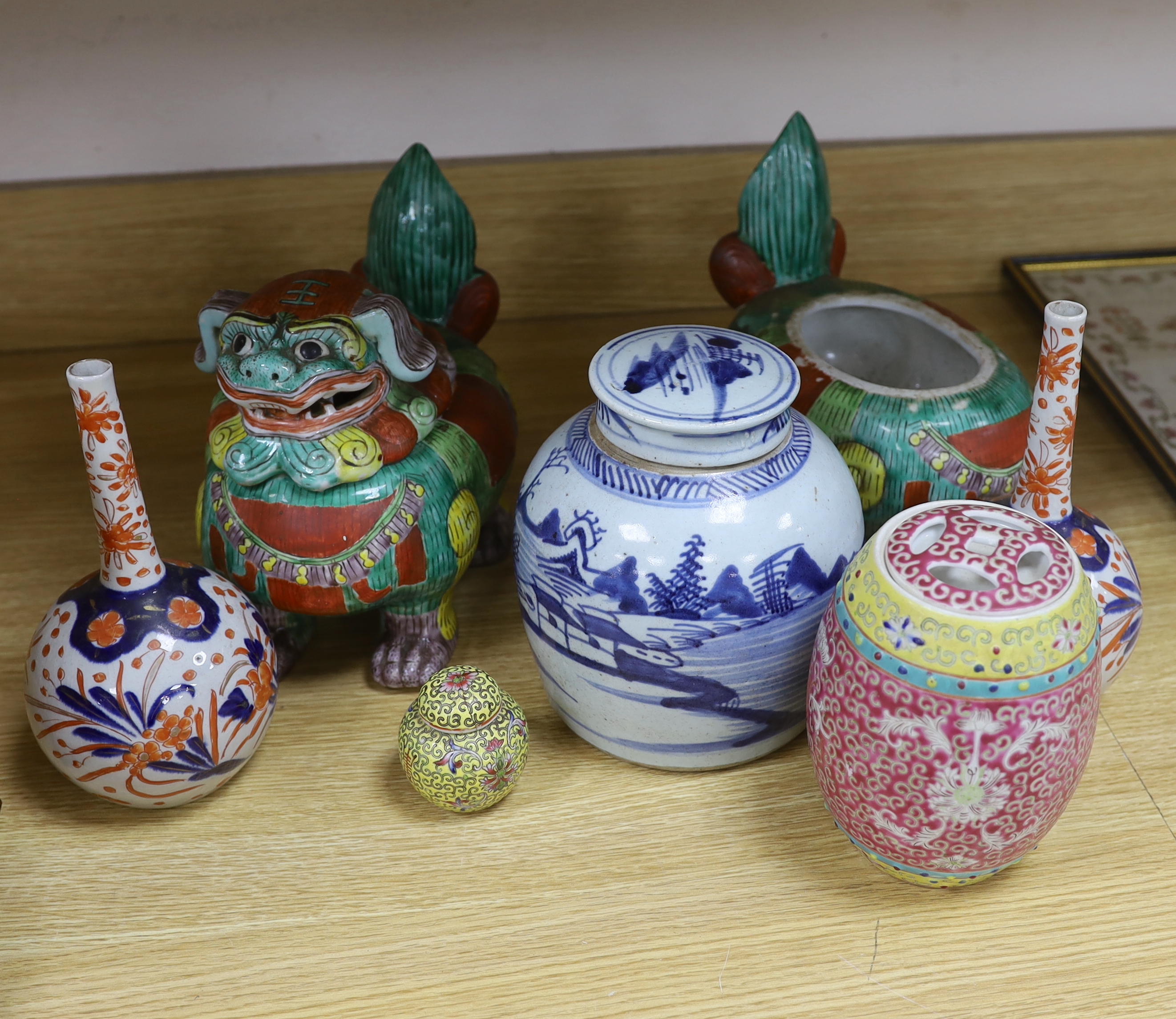 A collection of 20th century Chinese and Japanese ceramics including pair of Imari bottle neck vases, blue and white jar and cover and a pair of dog of foo pots and covers (one cover missing) the largest 23cm wide       