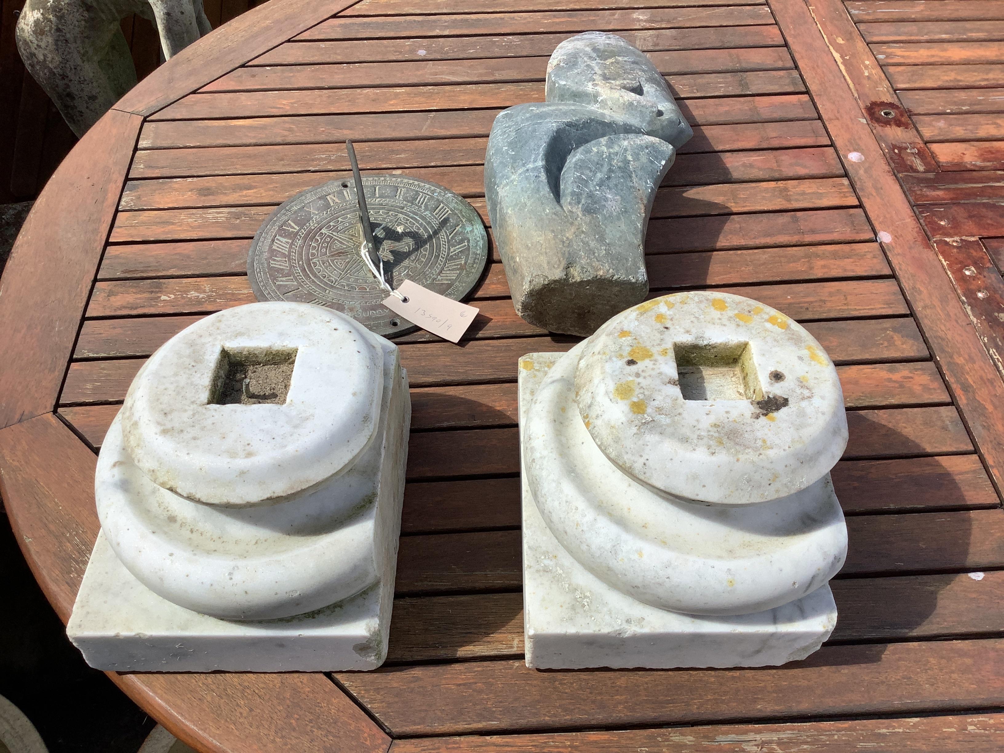 A pair of marble column bases, a sundial and a carved stone garden ornament, height 40cm                                                                                                                                    