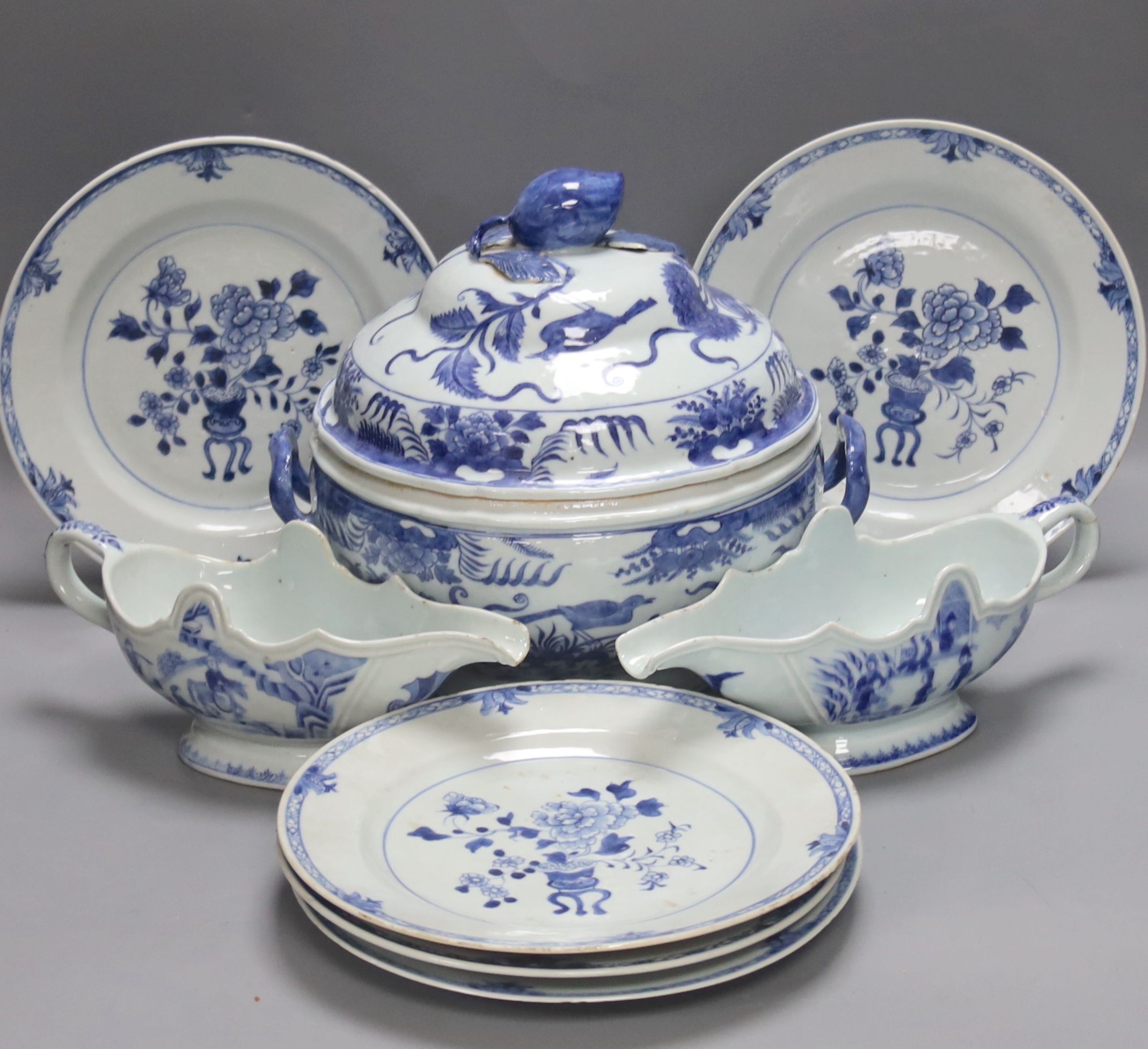 An 18th century Chinese Export blue and white octagonal tureen and cover, decorated with birds and flowers, a pair of similar sauceboats and five plates decorated with urns of flowers                                     