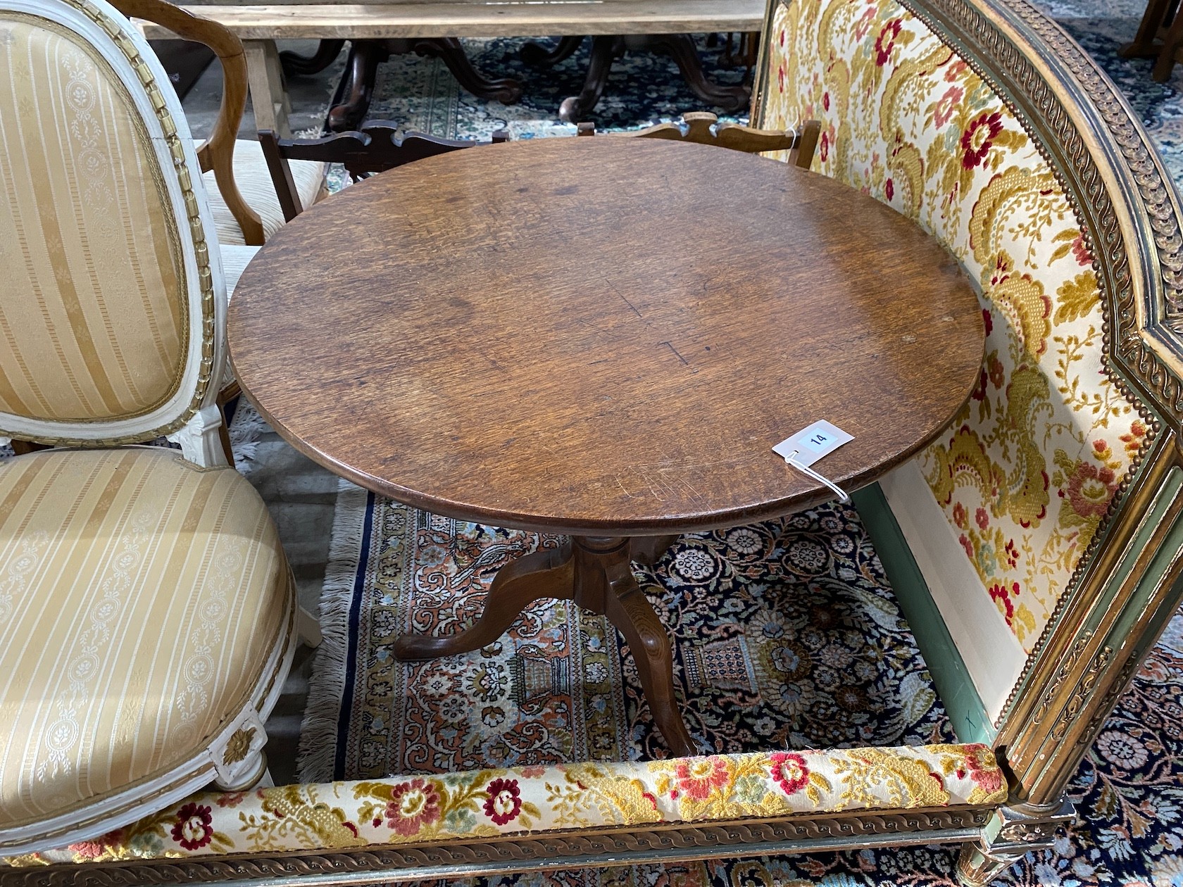 A George III oak circular tilt top tea table, diameter 82cm, height 72cm                                                                                                                                                    