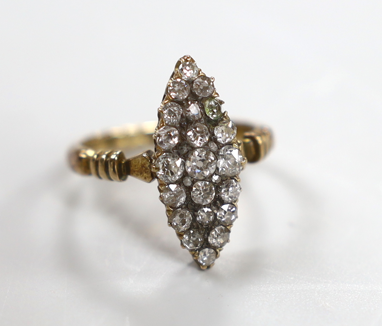 An early 20th century 18ct and diamond cluster set marquise shaped ring (one stone replaced not diamond), size P, gross weight 4.2 grams.                                                                                   