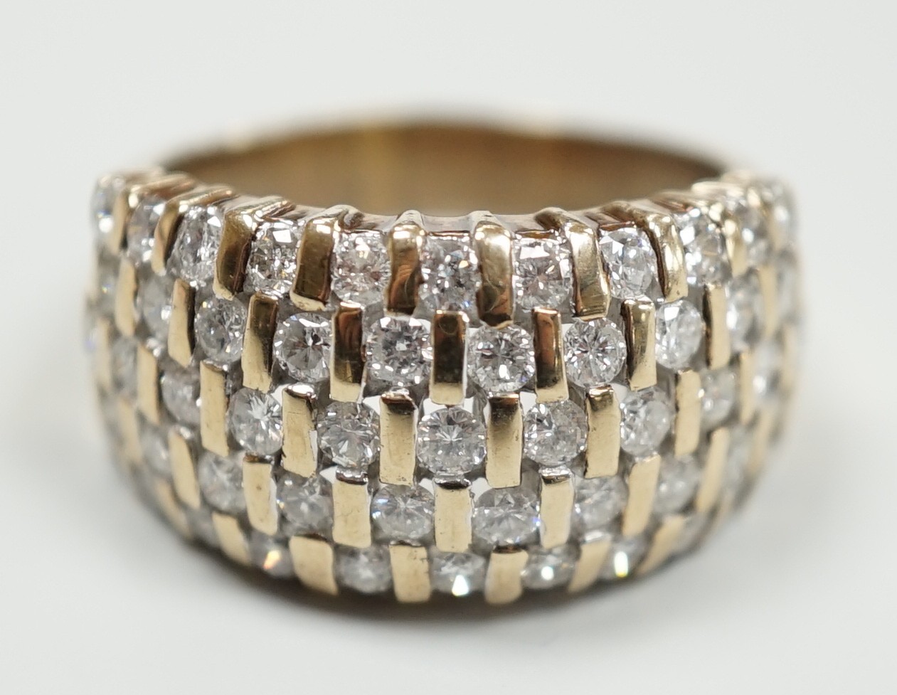 A modern yellow metal and pave set five row diamond dress ring, size R, gross weight 9.2 grams.                                                                                                                             