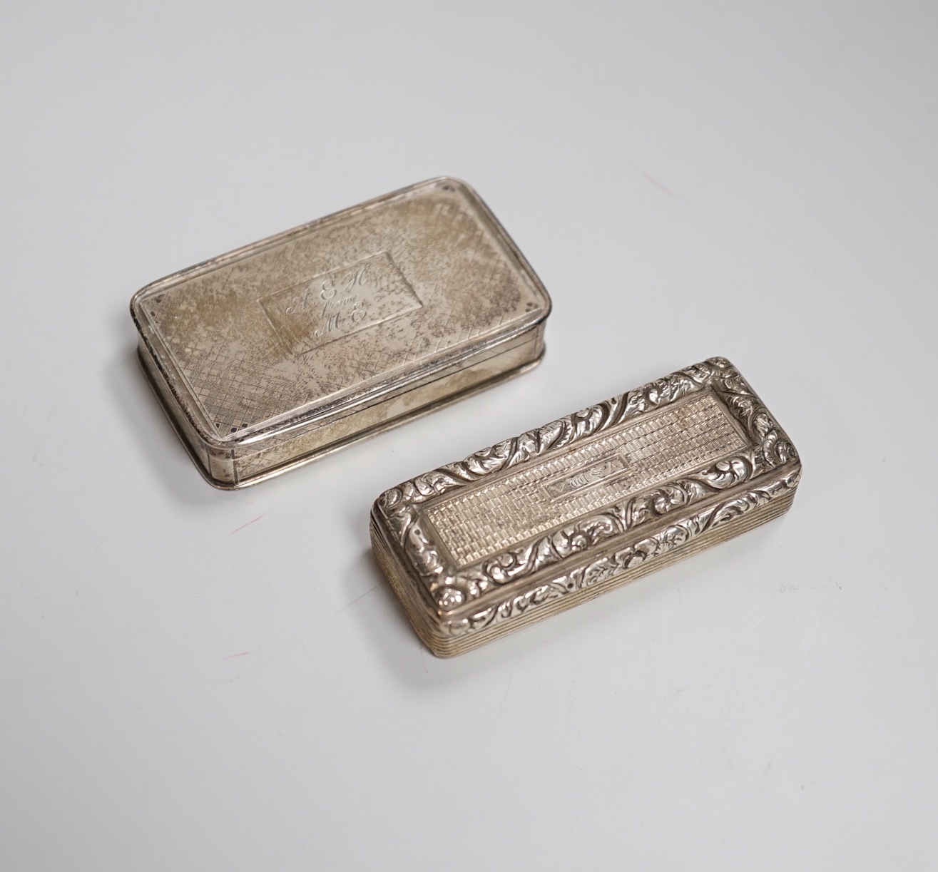 A George IV engine turned silver snuff box, with foliate scroll thumbpiece and banding, maker ES, Birmingham 1825, 6.75cm, 68 grams and a Nathaniel Mills engine turned snuff box, Birmingham 1827, 6.75cm, 60 grams        