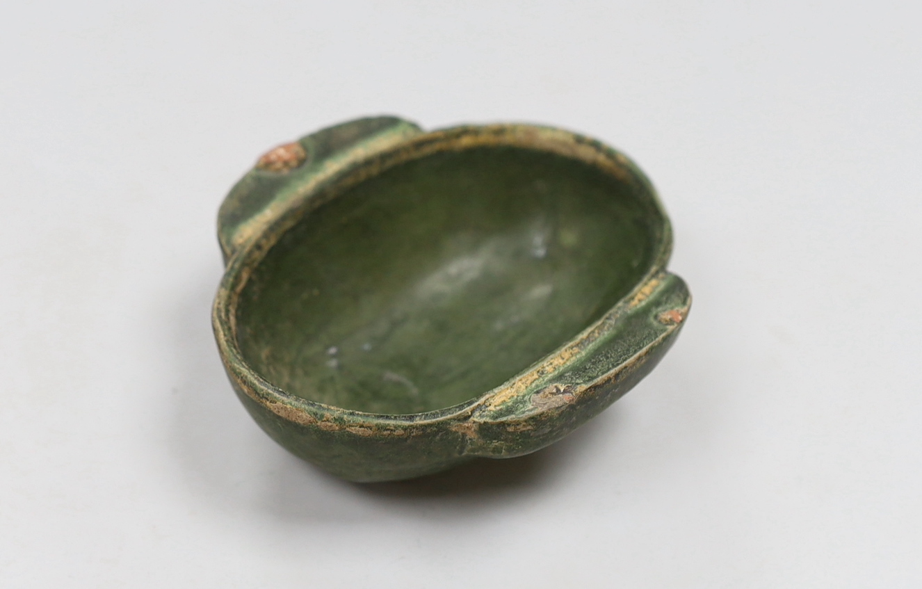 A Chinese Han dynasty green glazed stoneware ear cup, 9cm wide, 10cm long                                                                                                                                                   