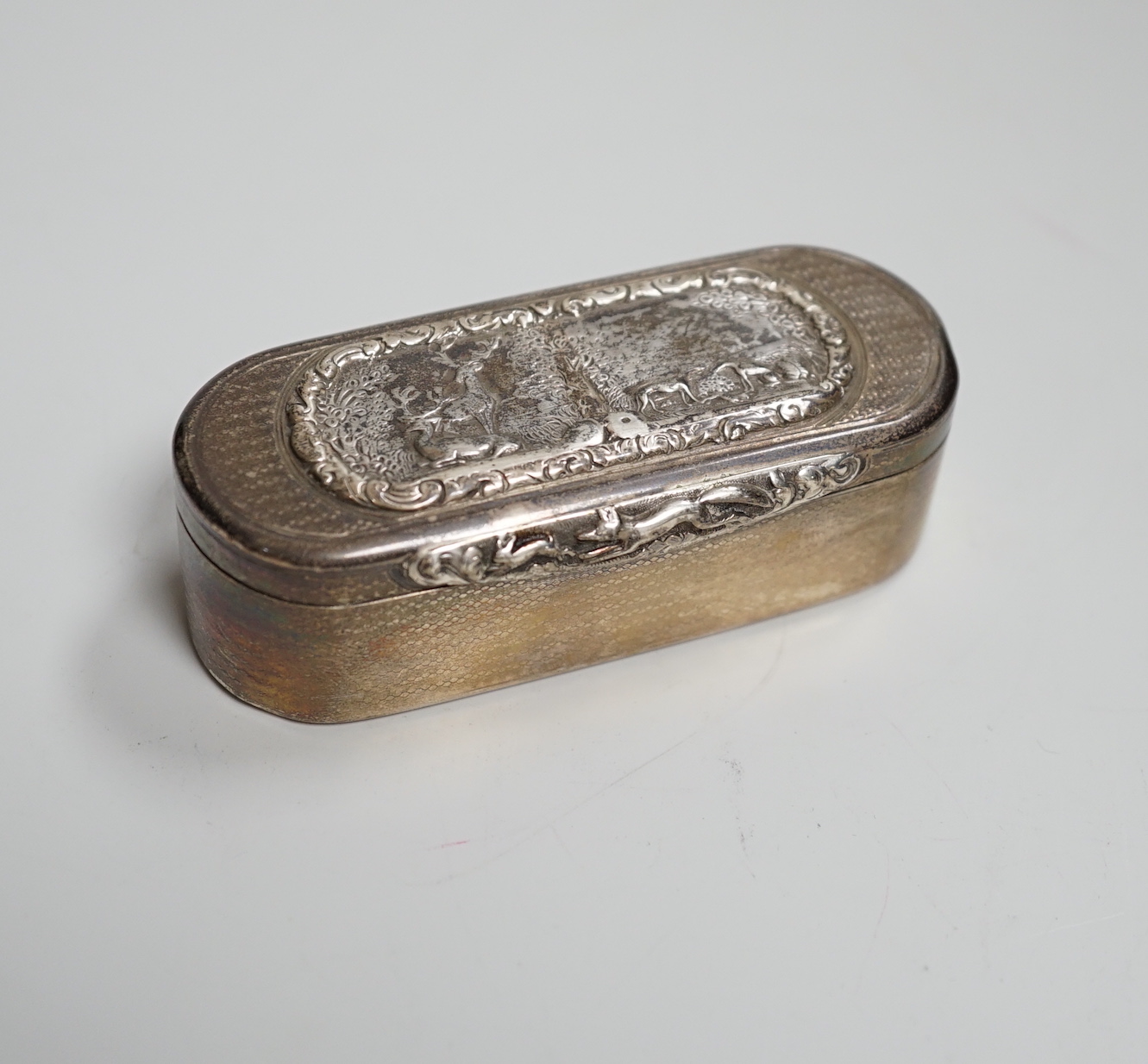 A George IV engine turned silver snuff box, the lid decorated with a panel of stags and hounds in landscapes, John Jones III, London 1824, 8.5cm, 127 grams                                                                 