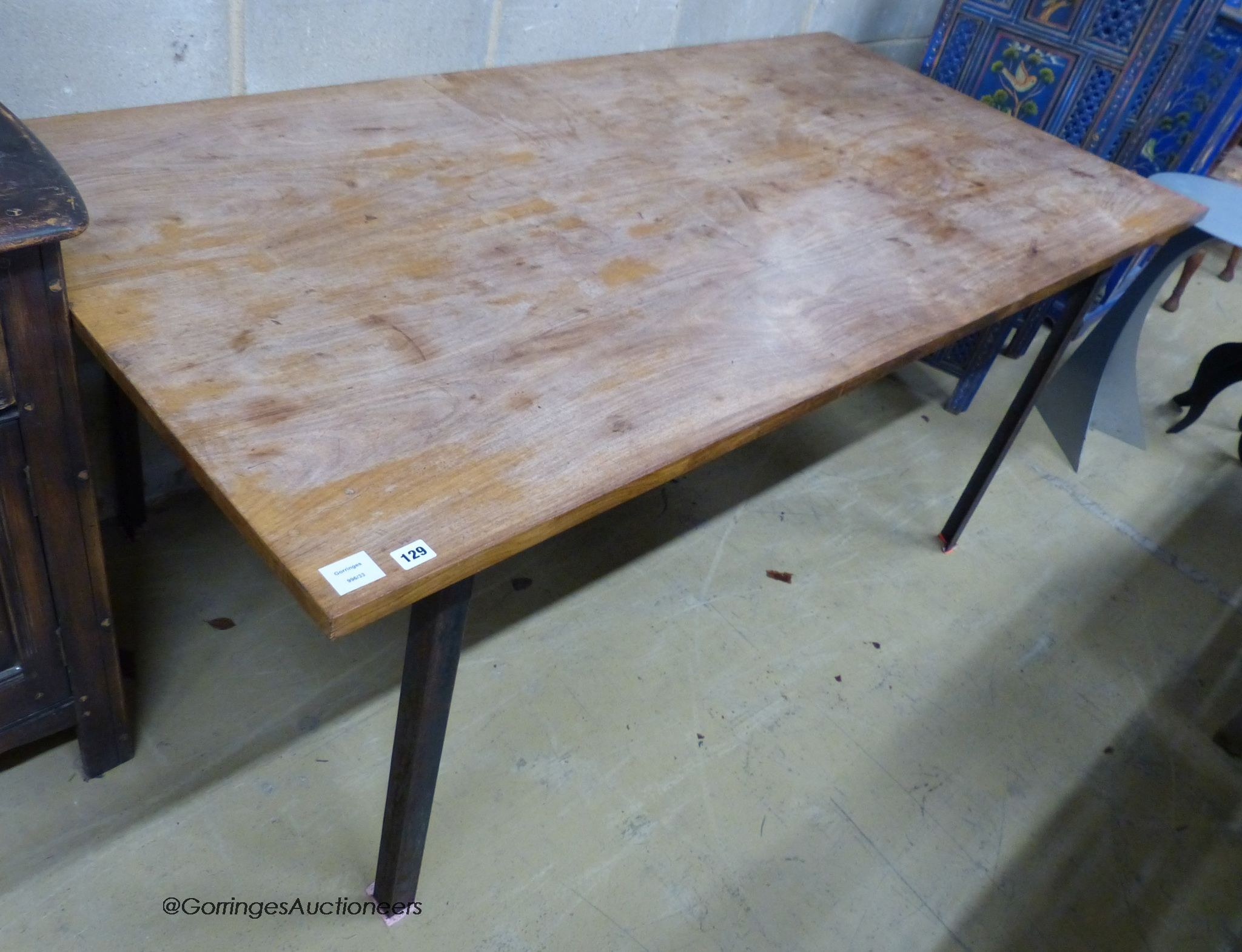 A walnut veneer and steel rectangular dining table, designed and made by Bill Gill, circa 1960, length 185cm, depth 90cm, height 74cm                                                                                       