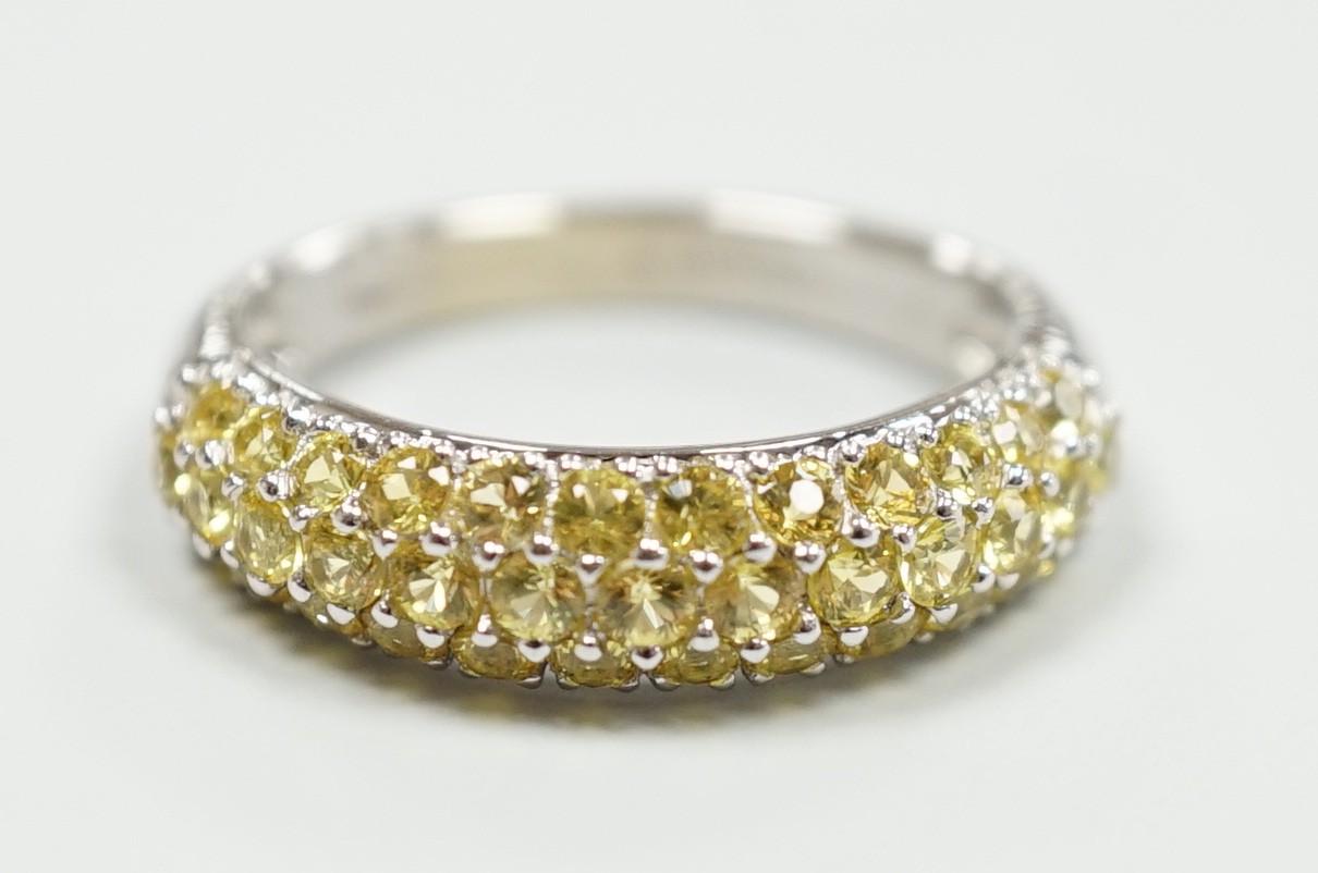 A modern 18ct white gold and yellow stone cluster set half hoop ring, size K, gross weight 4.2 grams.                                                                                                                       