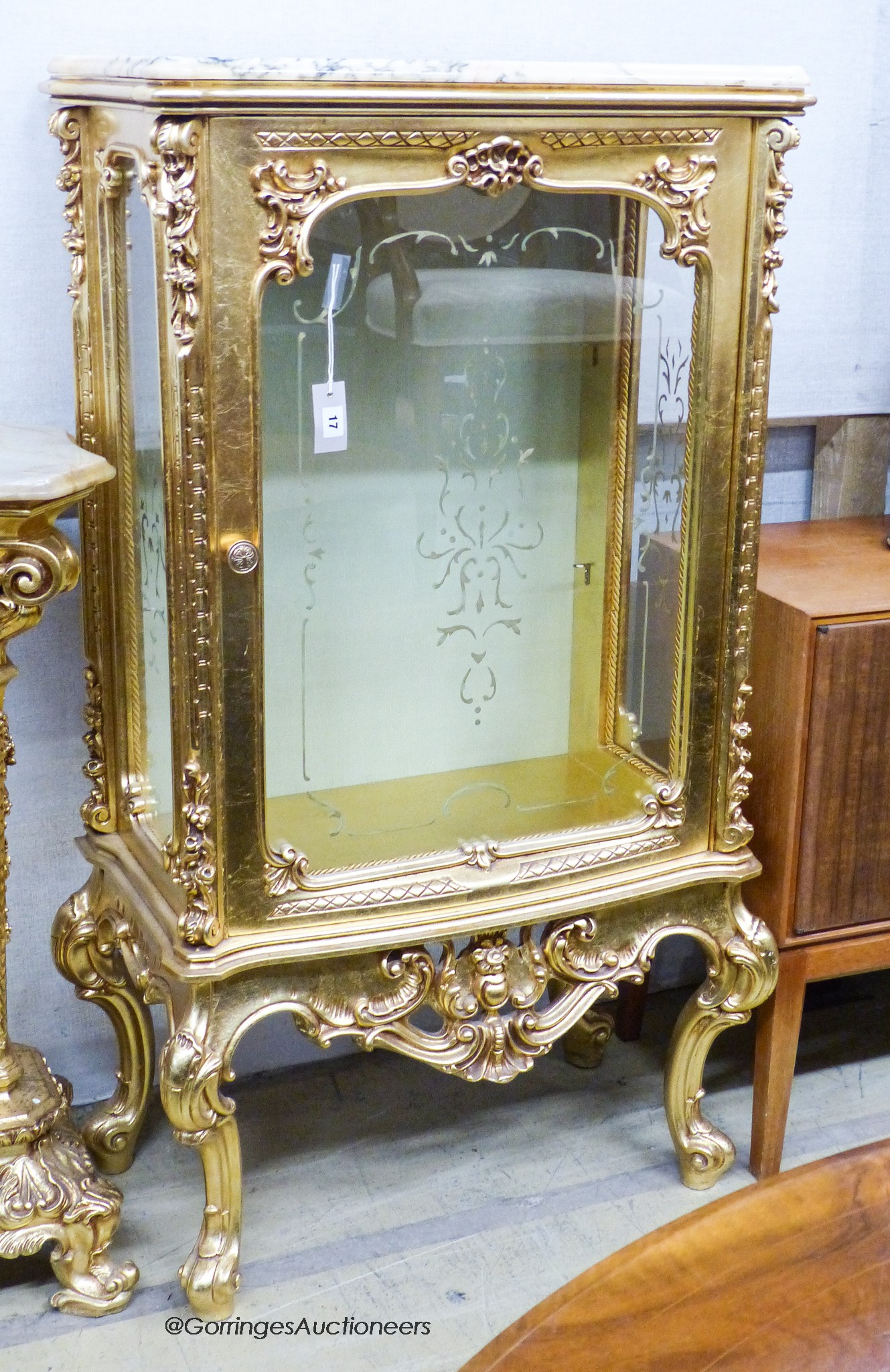 A marble topped gilt vitrine, width 73cm, depth 41cm, height 137cm                                                                                                                                                          