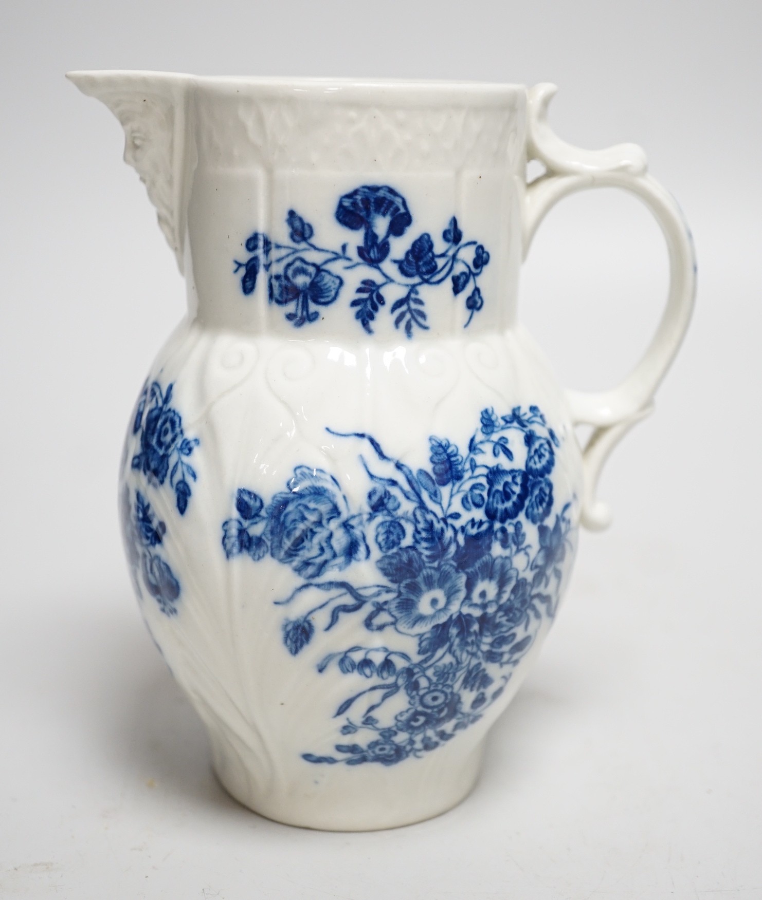 An 18th century Caughley mask jug printed with bouquets, C mark to base, 14.5cms high                                                                                                                                       