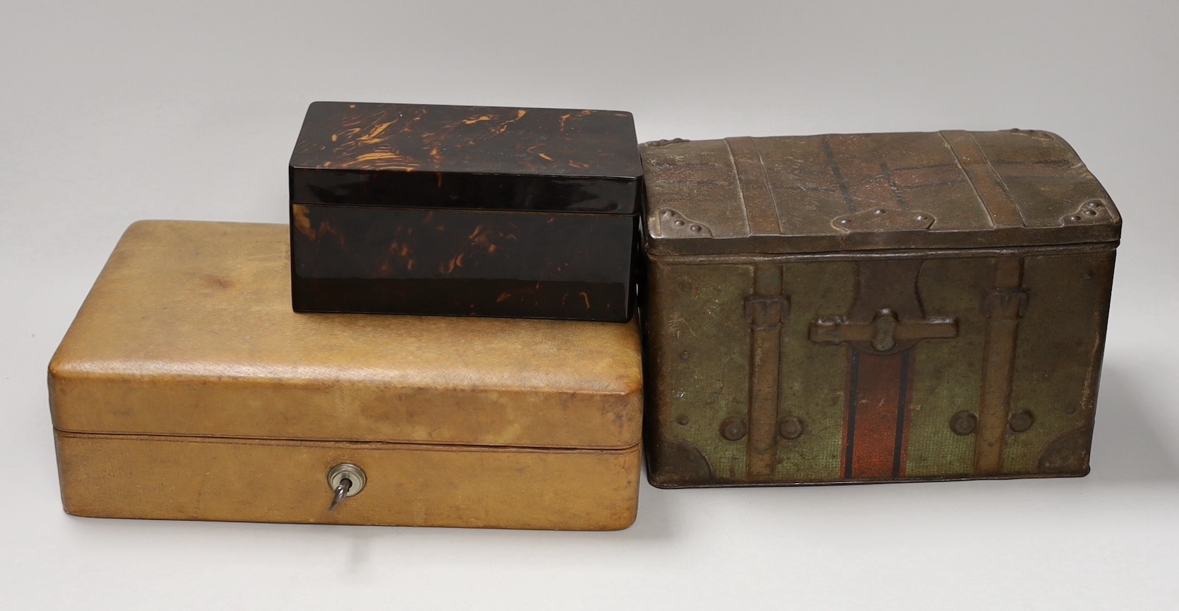 A leather Bramah jewellery case, a tortoiseshell cigarette box and a biscuit box. Widest 25.5cm                                                                                                                             