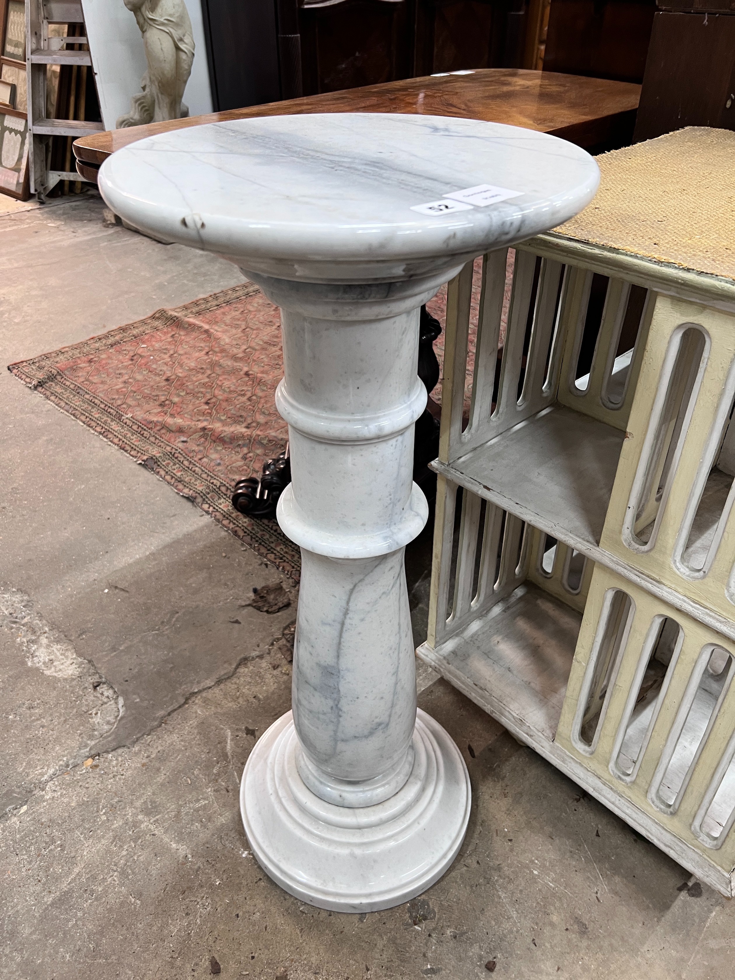 A circular marble pedestal, diameter 35cm, height 80cm *Please note the sale commences at 9am.                                                                                                                              