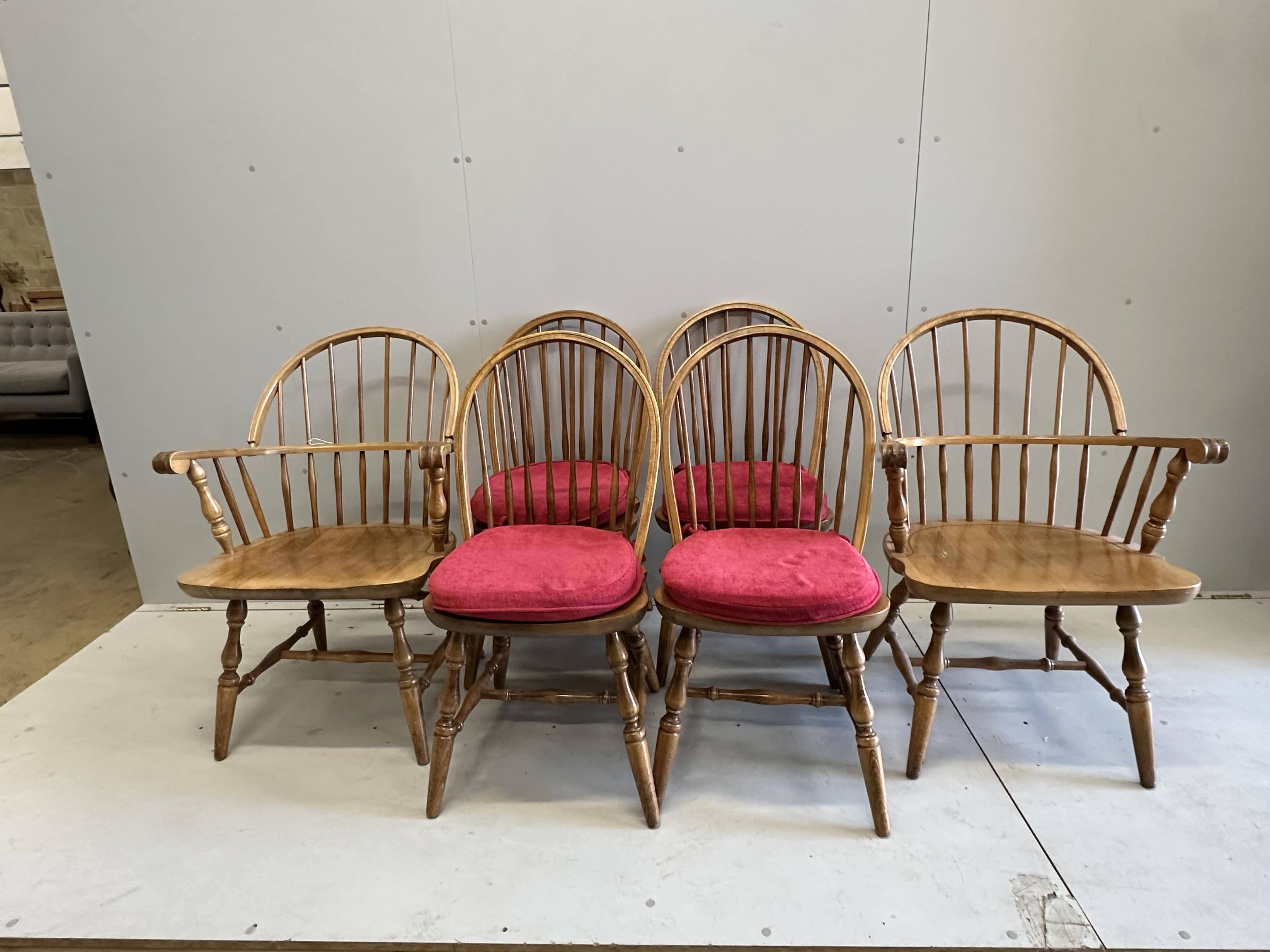 A set of six beech Windsor dining chairs, two with arms. Condition - fair                                                                                                                                                   