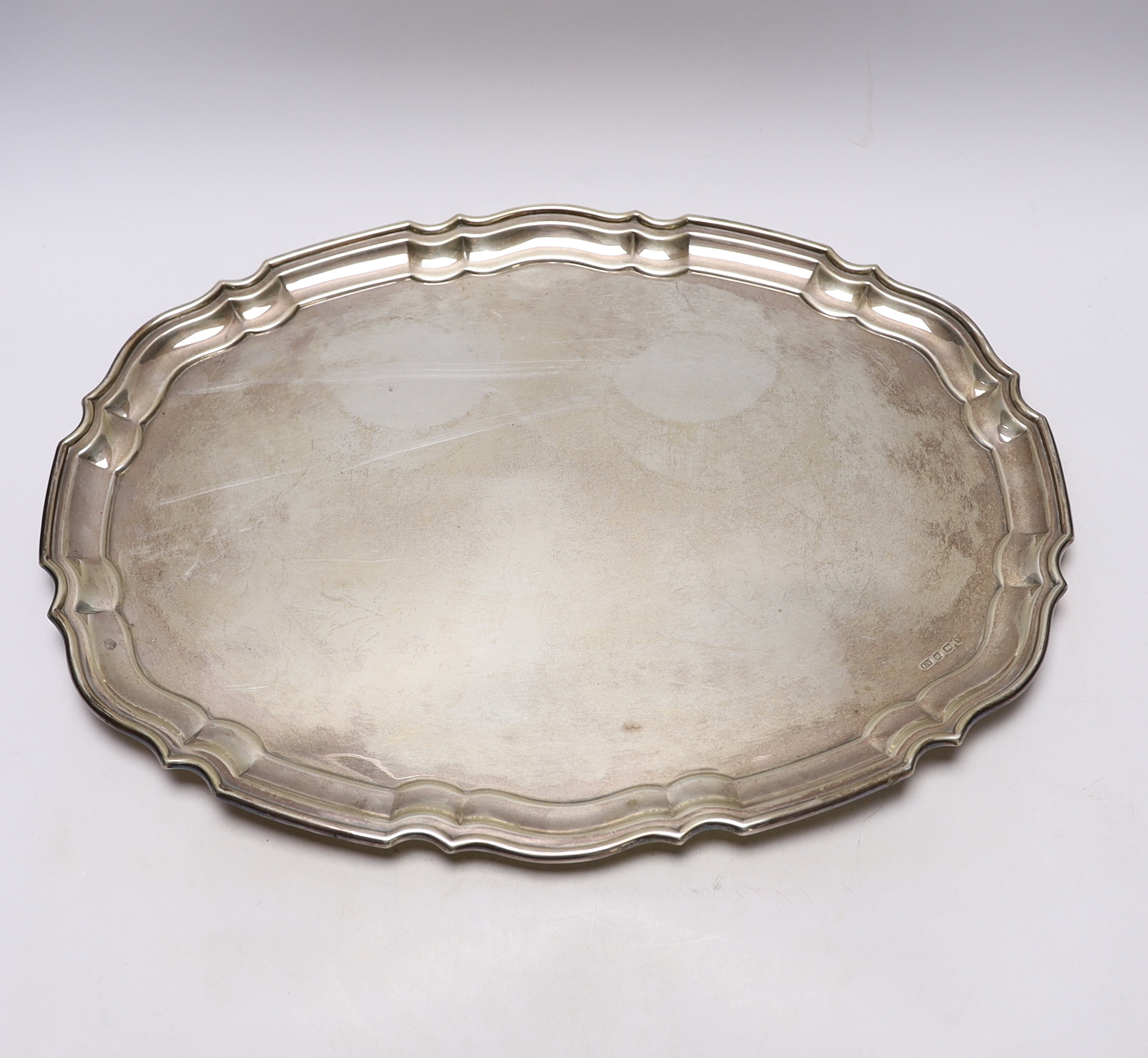 A George V silver shaped oval tray, by Viners Ltd, Sheffield, 1938?, on four ball feet, 46.5cm, 52.2oz.                                                                                                                     