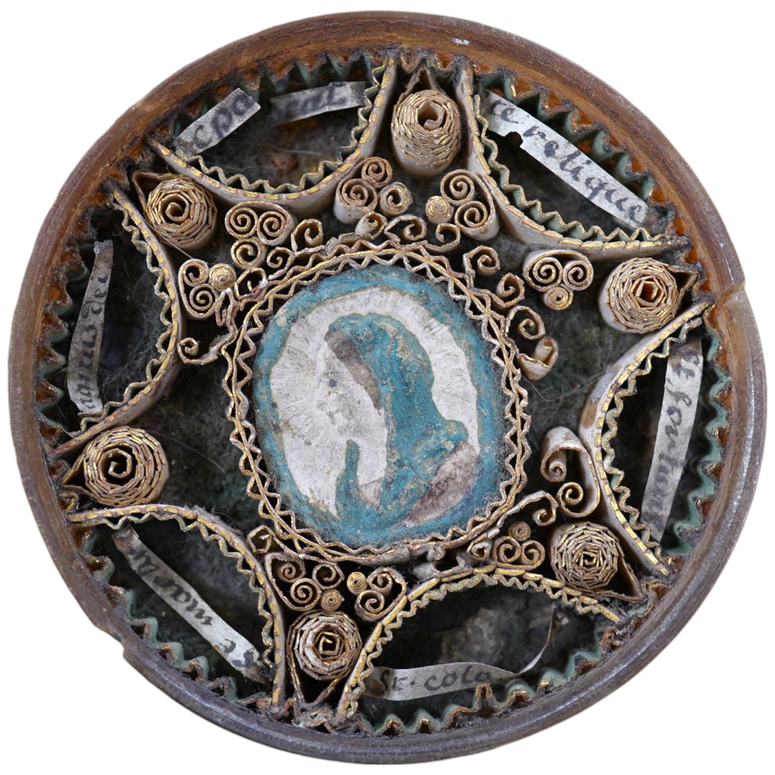 An early 19th century devotional reliquary rolled paper roundel, 7cm in diameter. Condition - fair                                                                                                                          