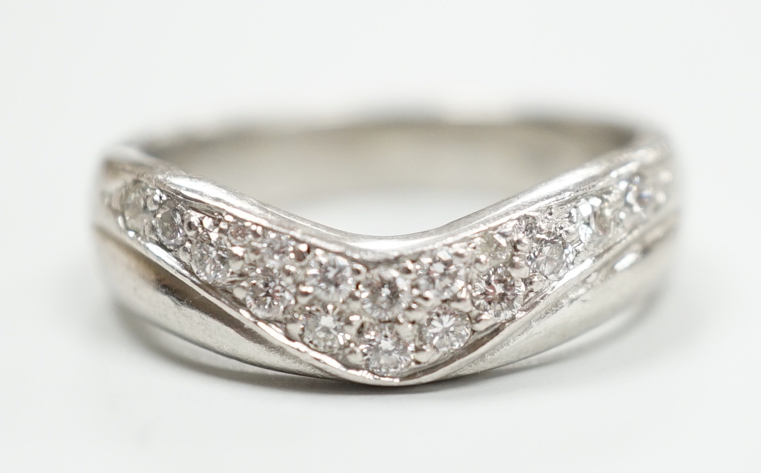 A modern platinum and diamond cluster set 'chevron' ring, size N, gross weight 9.2 grams.                                                                                                                                   