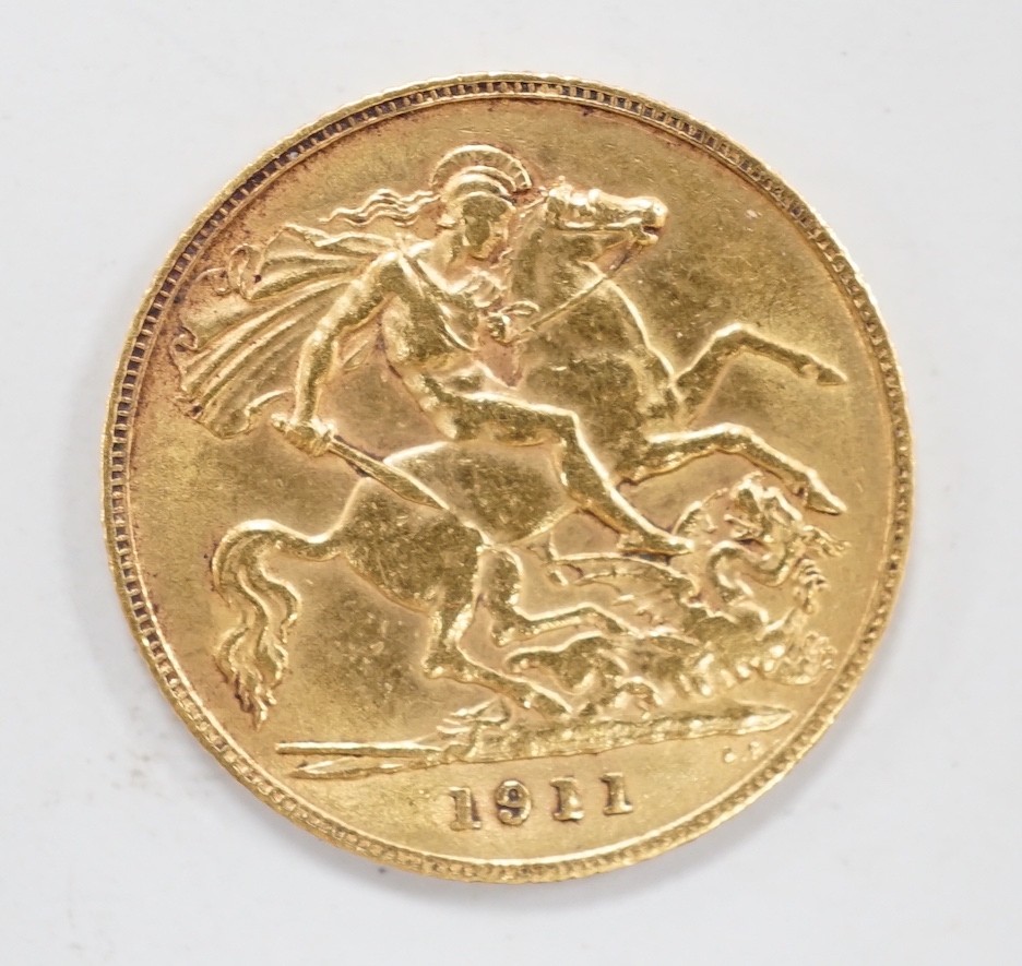 A George V 1911 gold half sovereign, with leather purse.                                                                                                                                                                    