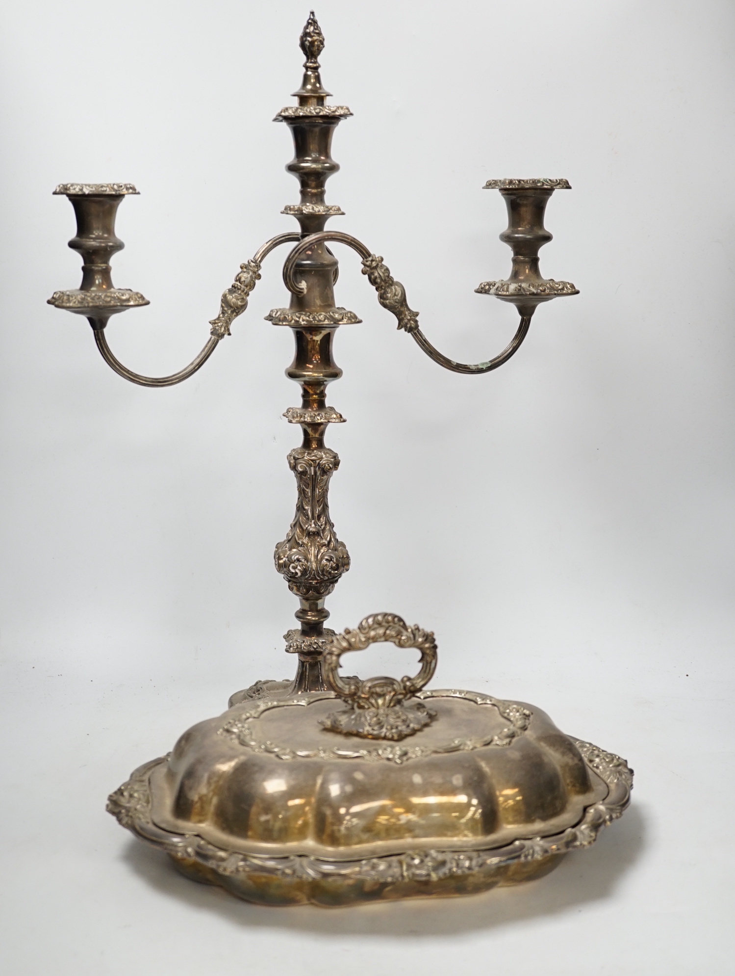 A silver plated entree dish and cover and a pair of three light candelabra, tallest 55cm                                                                                                                                    