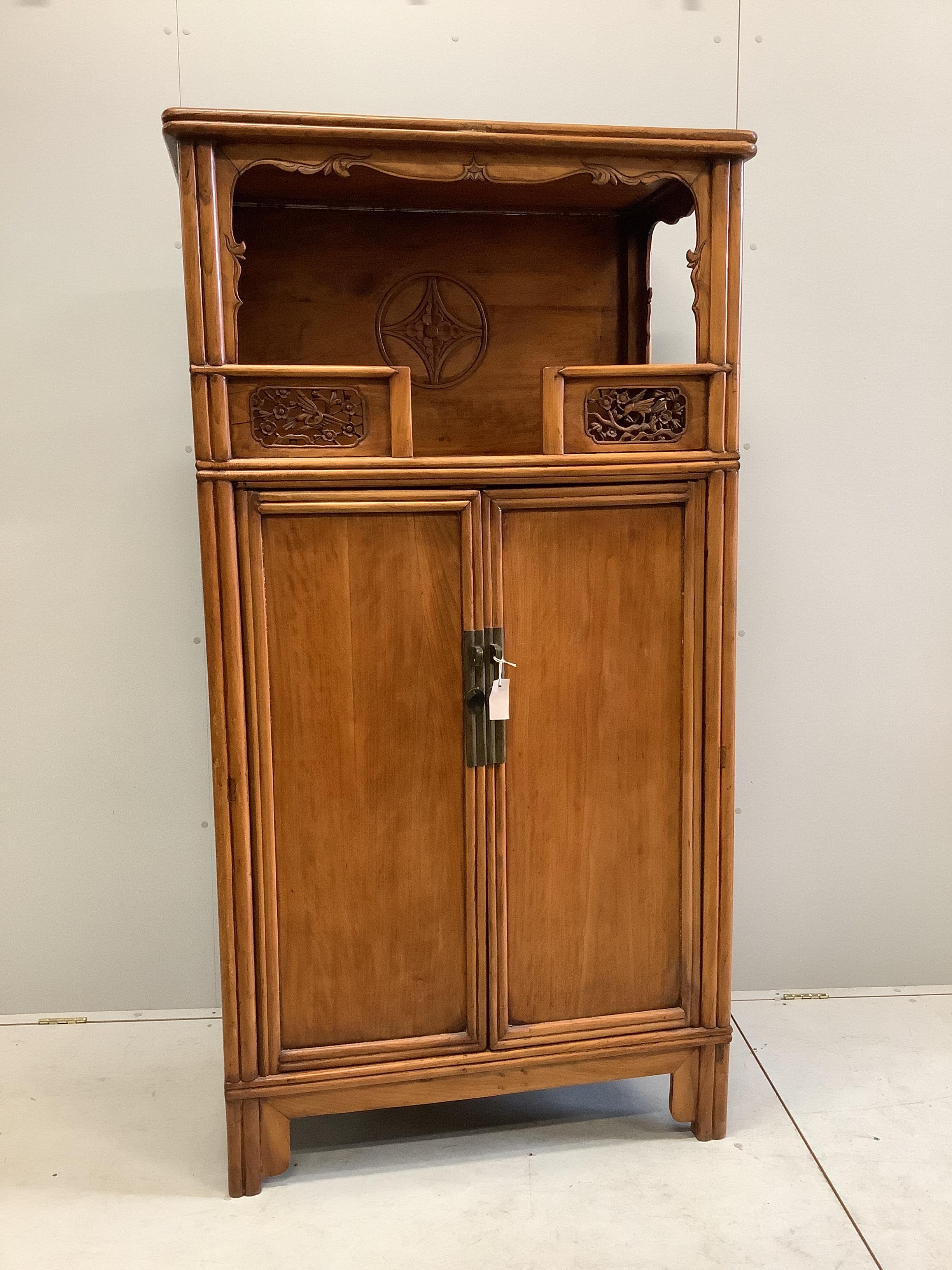 A Chinese carved elm cabinet, width 82cm, depth 55cm, height 182cm                                                                                                                                                          