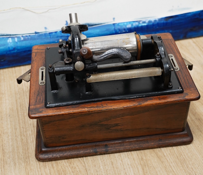 An oak cased Edison phonograph with ten rolls and a small table top polyphon with twelve 8 inch discs (2). Condition - fair to good.                                                                                        