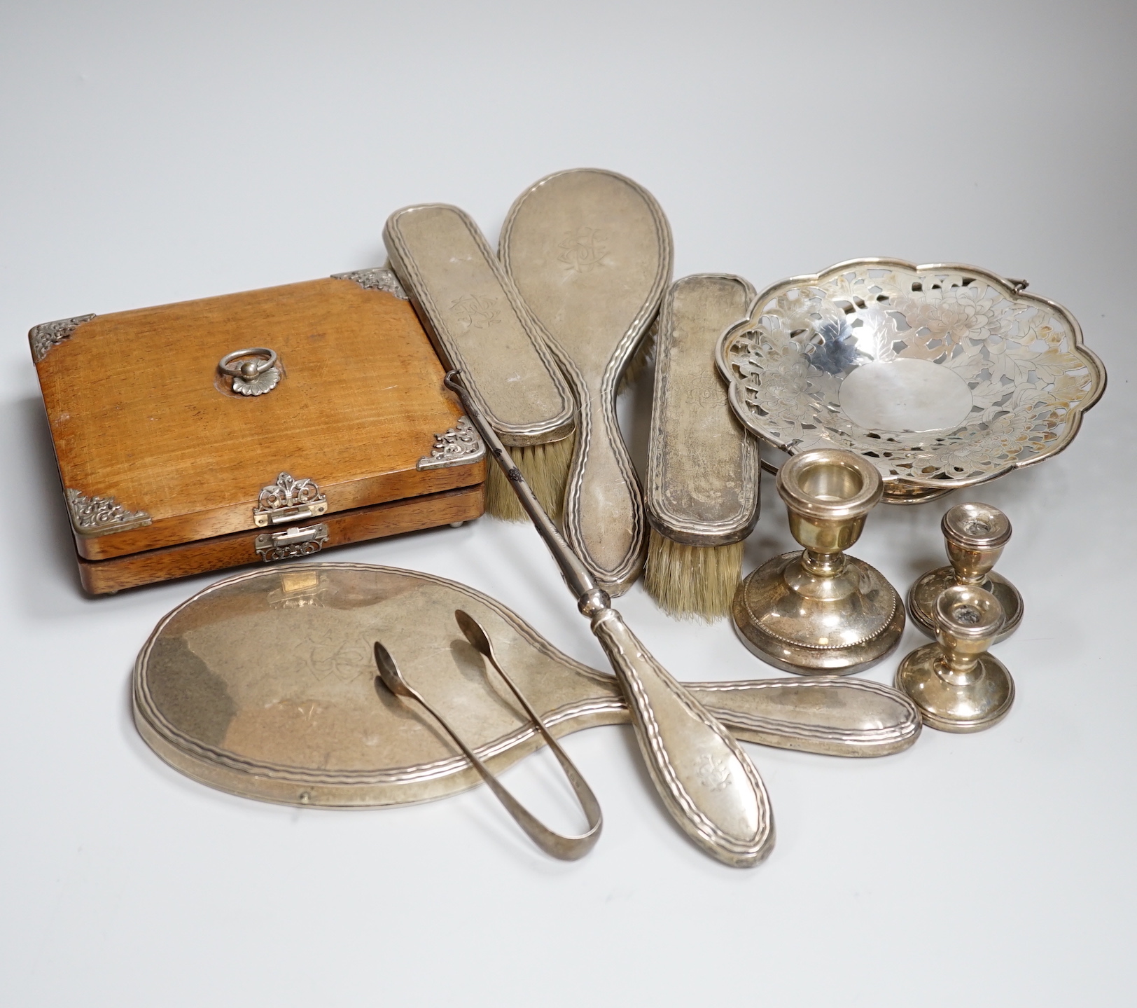 A group of assorted small silver comprising a set of six Victorian silver coffee spoons, Sheffield 1888, 75 grams, in an ornate Continental white metal mounted box, a five piece George V silver mounted dressing table set