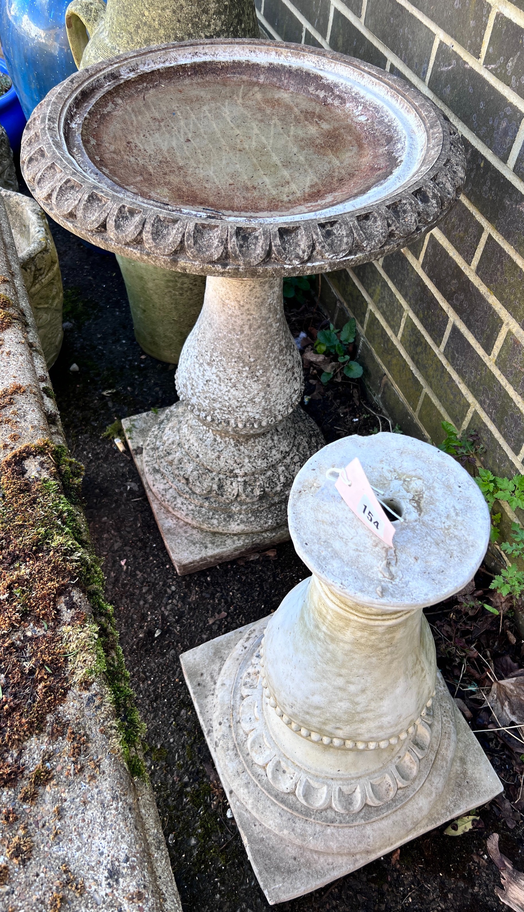 A circular reconstituted stone bird bath, diameter 50cm, height 62cm together with a faux marble pedestal *Please note the sale commences at 9am.                                                                           