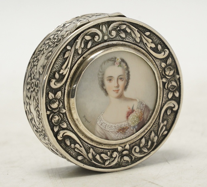 An early 20th century continental white metal circular snuff box, the cover with inset miniature watercolour of a lady signed Drepize?, 58mm. Condition - fair to good                                                      