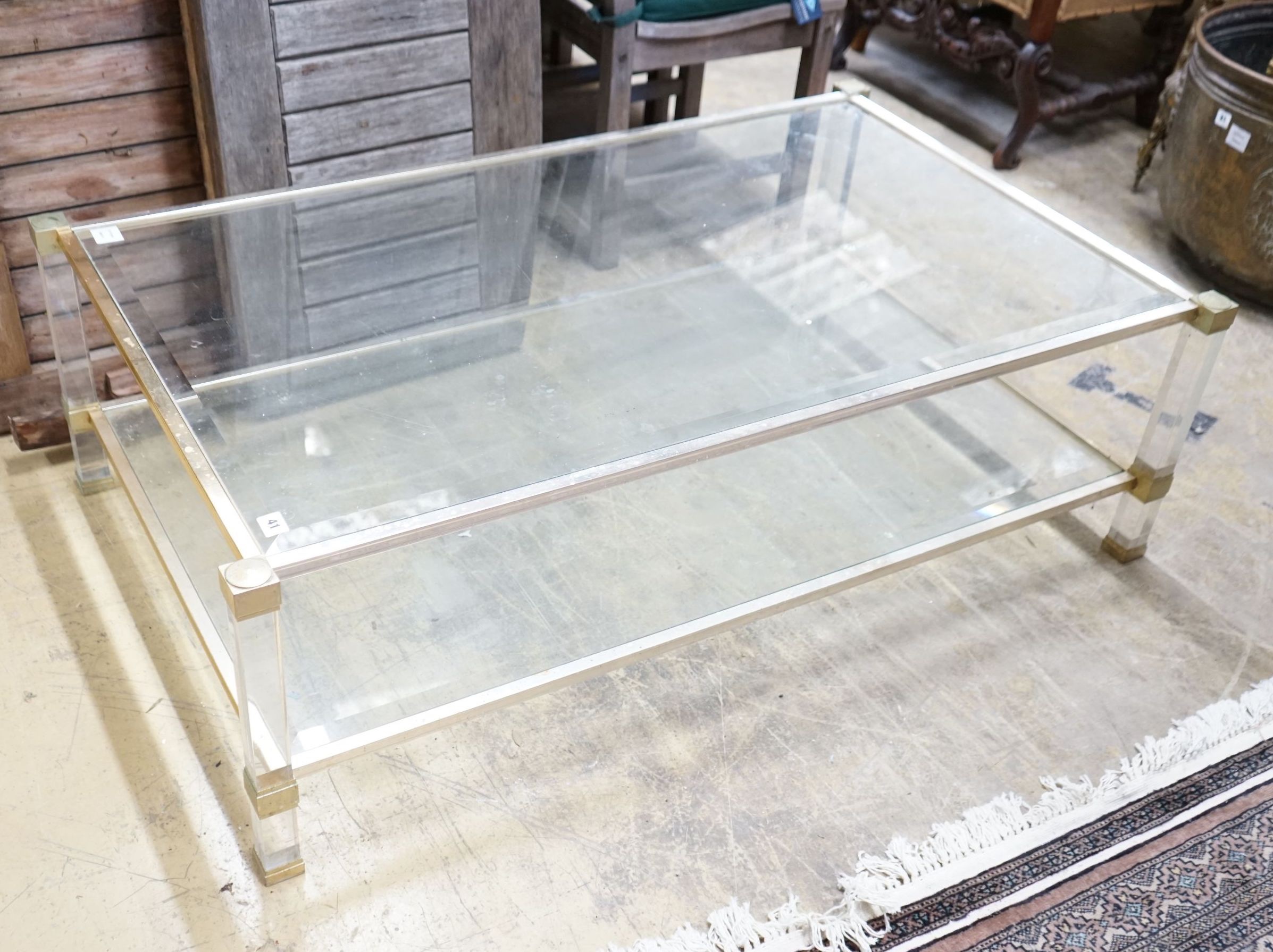 A contemporary metal and bevelled glass two tier coffee table, width 128cm, depth 77cm, height 40cm                                                                                                                         