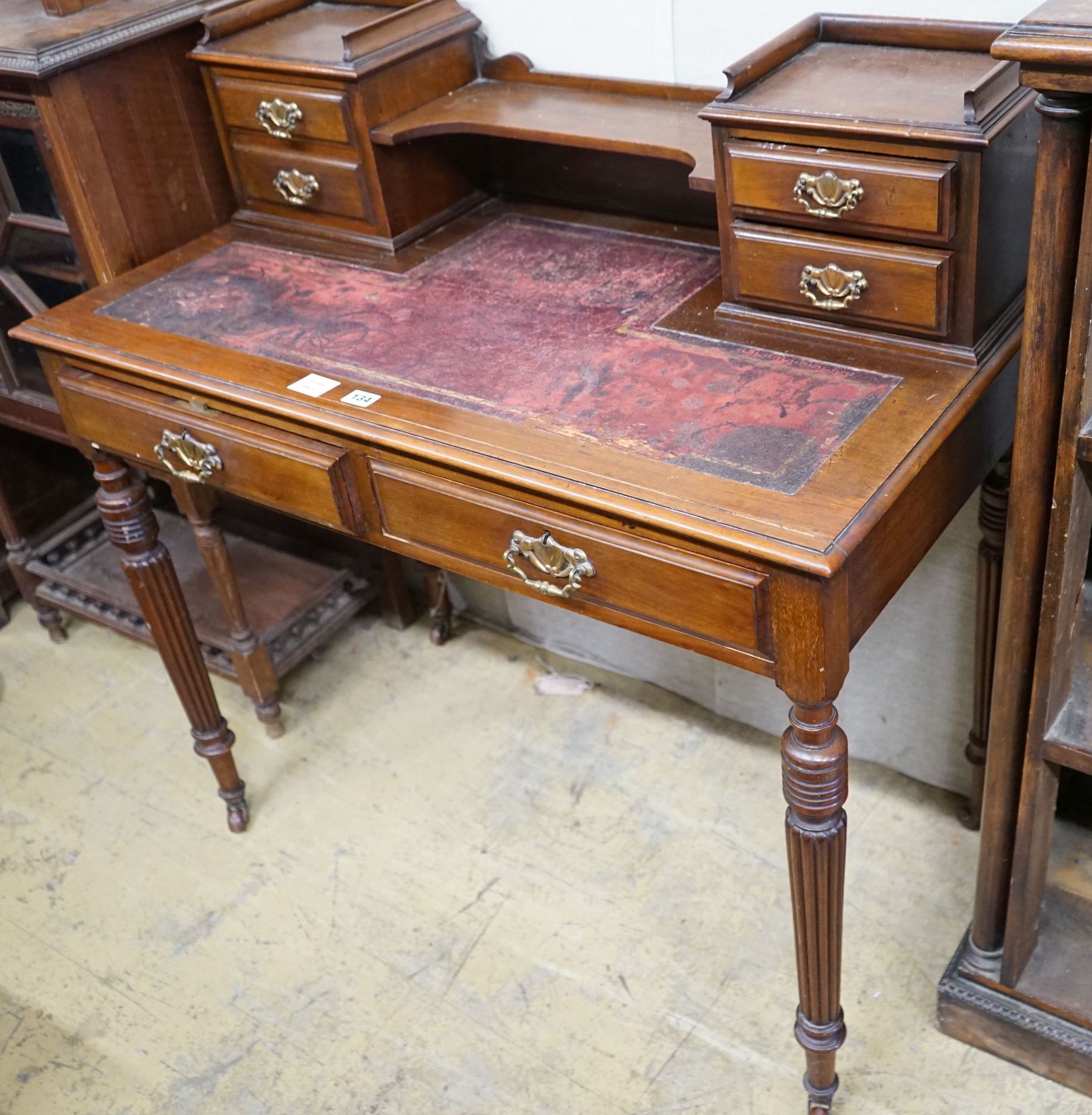 A late Victorian mahogany writing table, width 99cm, depth 52cm, height 100cm                                                                                                                                               