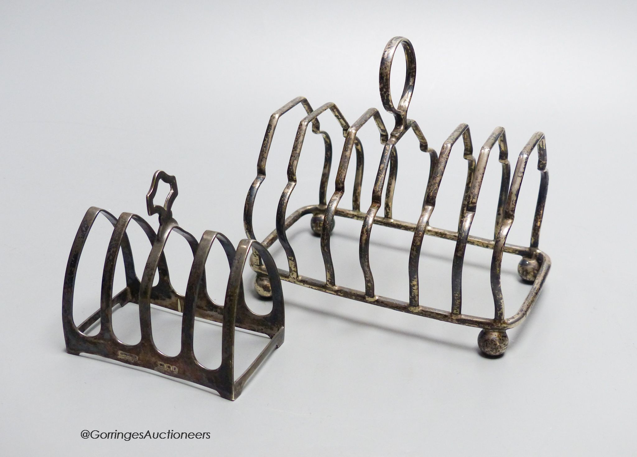 Two silver toast racks, Birmingham 1918, 5.1oz., 2.5 cm and London 1932, 1.8oz, 7.5 cm                                                                                                                                      