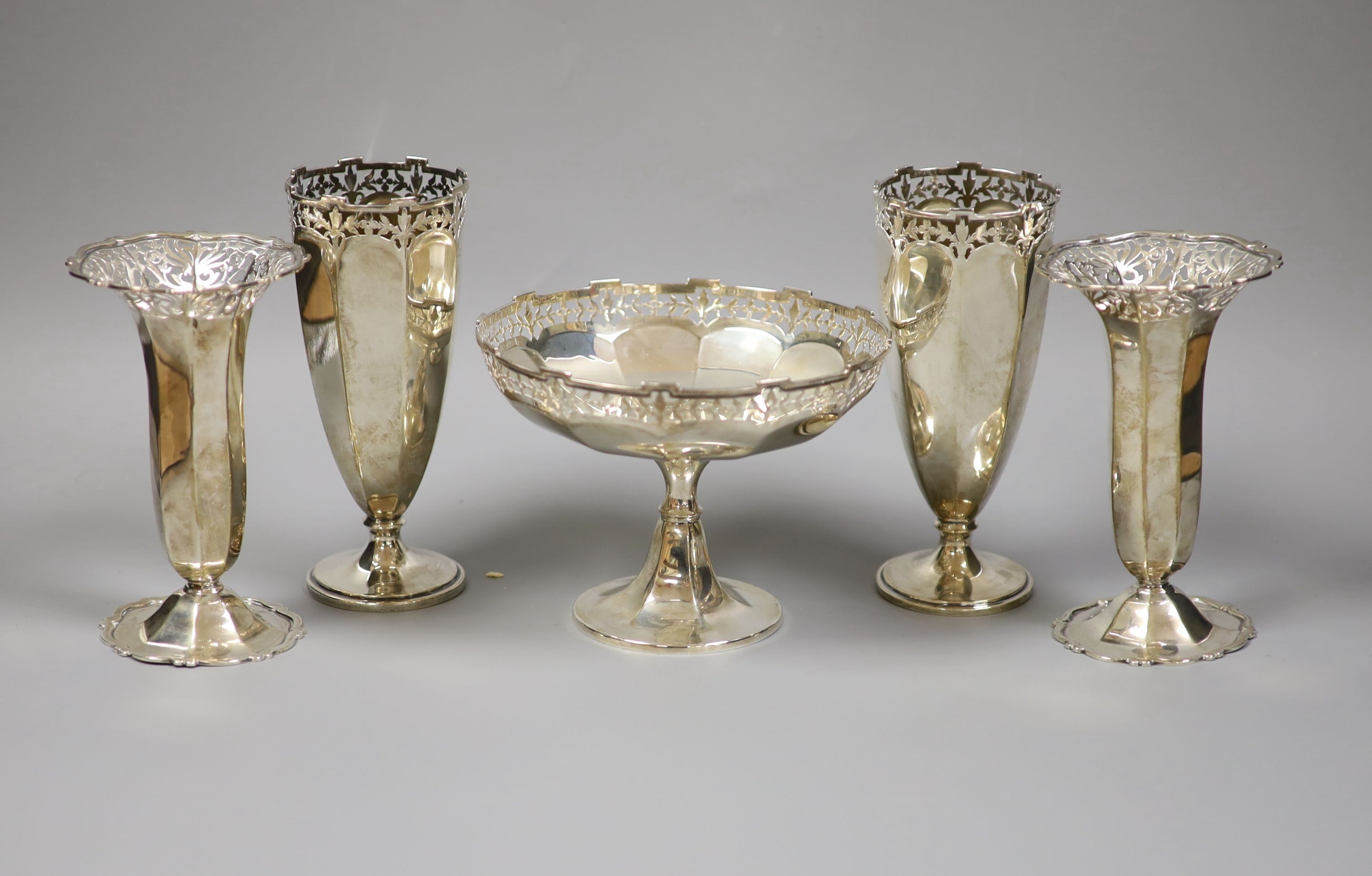 Two pairs Edwardian silver posy vases, London, 1901 and 1904, Goldsmiths & Silversmiths Co Ltd, together with a George V small pedestal bowl, Birmingham 1924 (mark rubbed) (5) total weight 24.0 ozt.                      