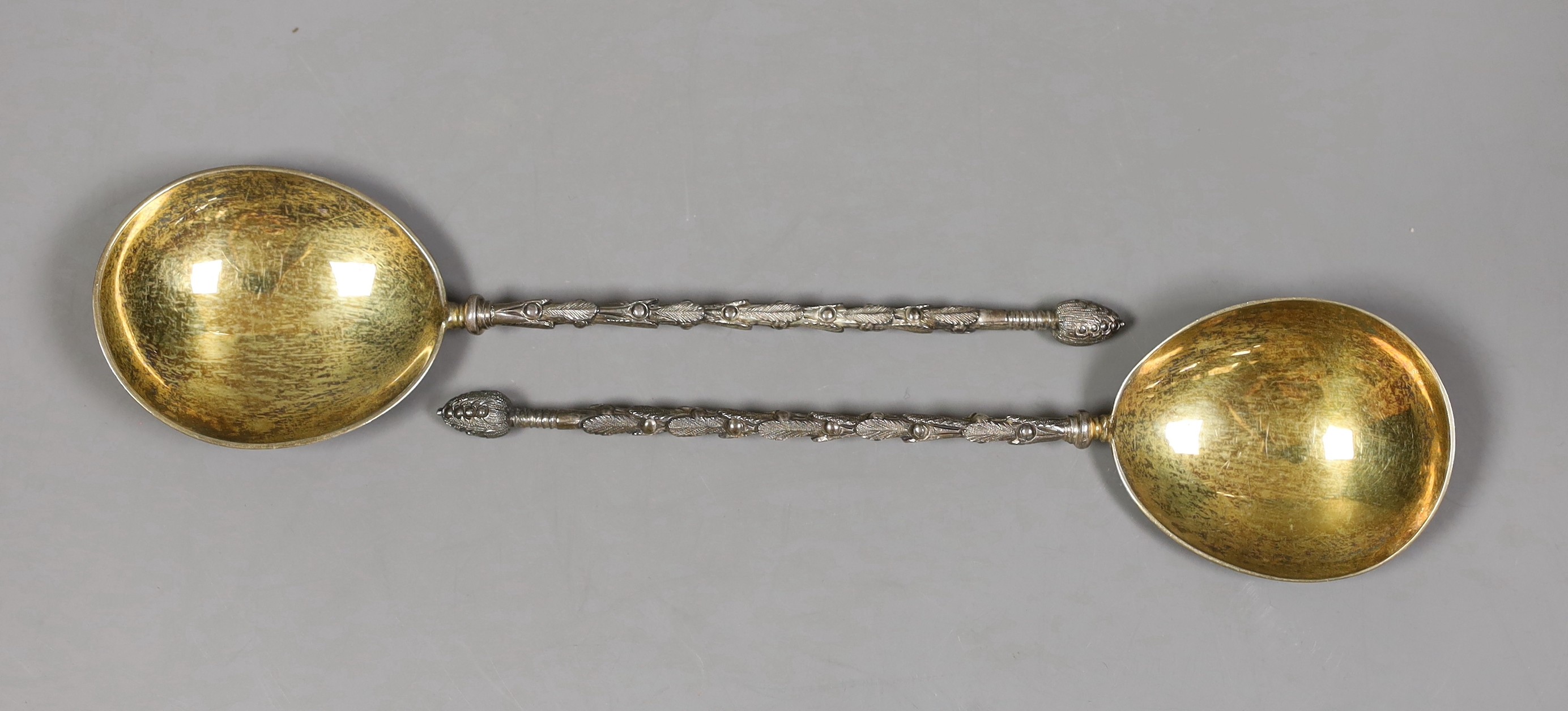 A pair of George V silver serving spoons, with ornate stems, Mappin & Webb, London, 1918/19, 19.6cm, 120 grams.                                                                                                             