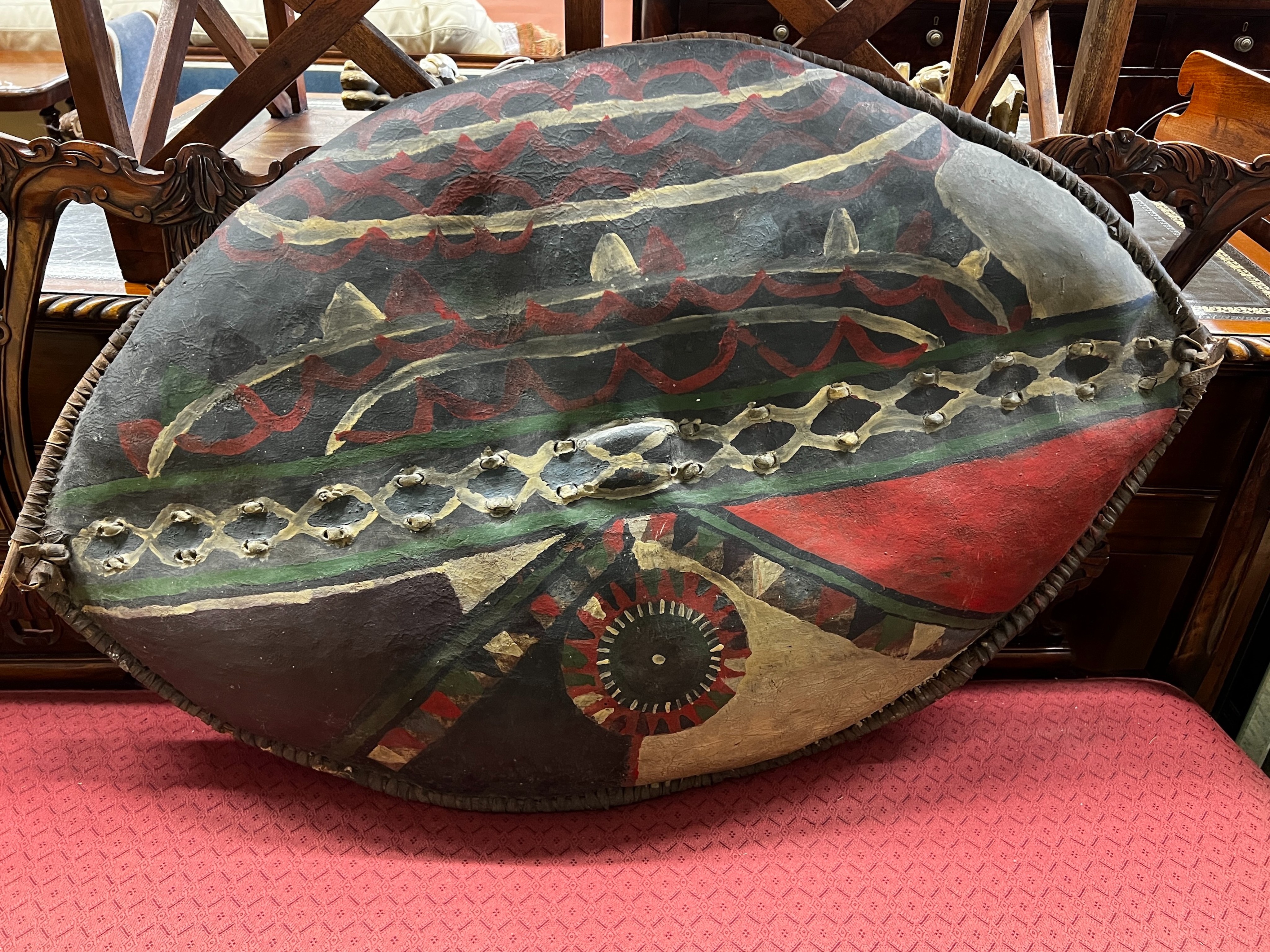 An African painted leather tribal shield, height 102cm                                                                                                                                                                      