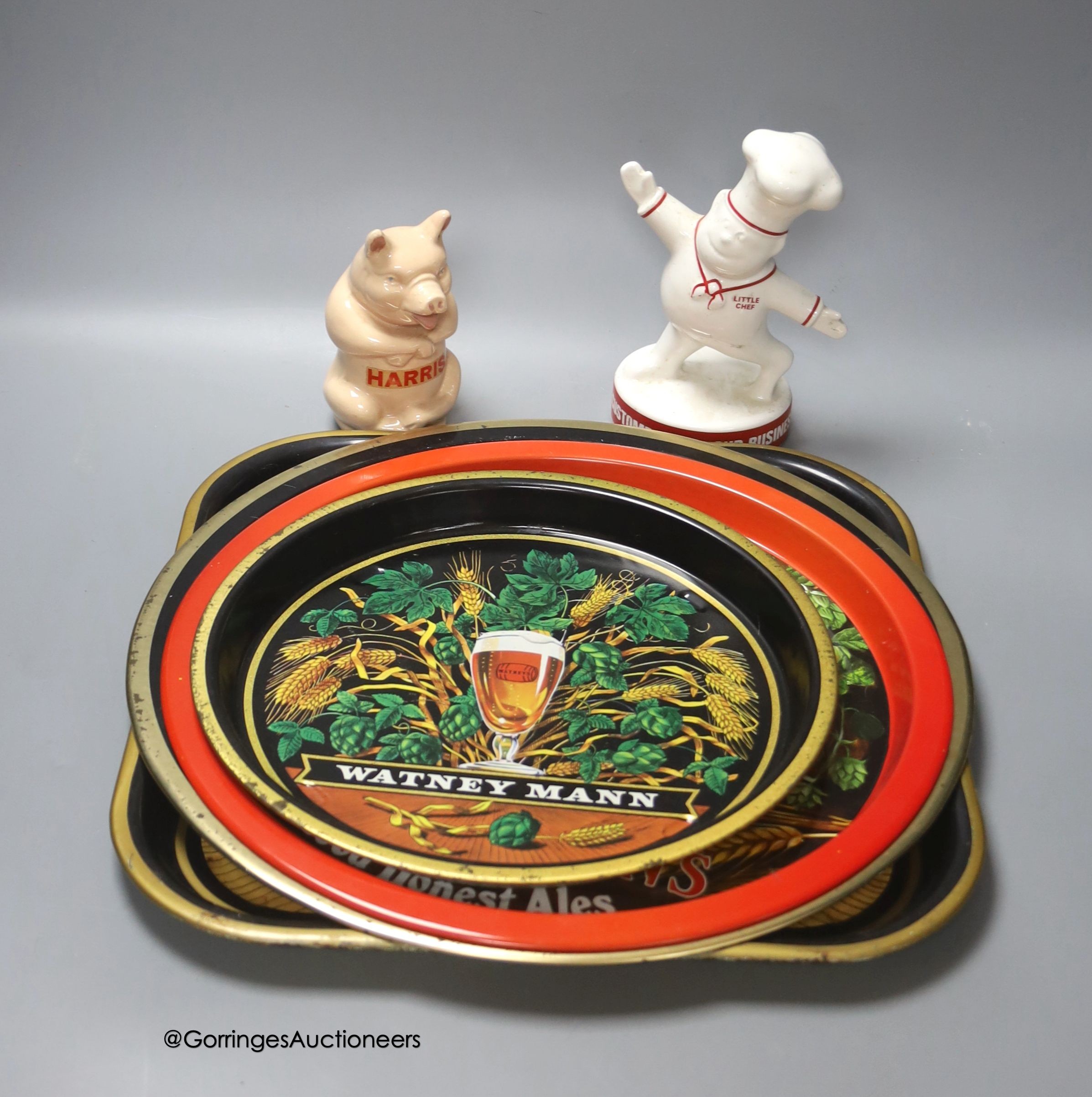 Three Watney's ale trays, a Batemans beer tray, a 'Harris' piggy bank and a Little Chef figure                                                                                                                              