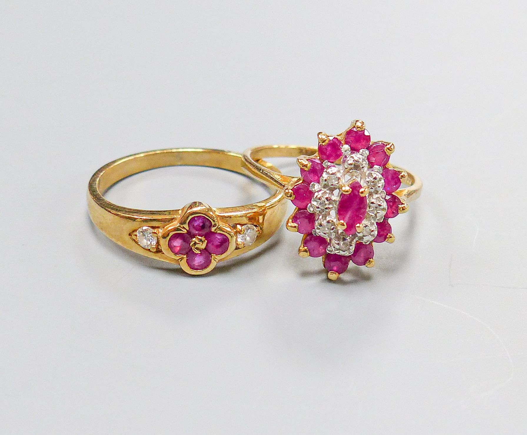 A 9ct yellow gold, ruby and diamond oval cluster ring, size M and another similar 9ct ring, gross 4.5 grams.                                                                                                                