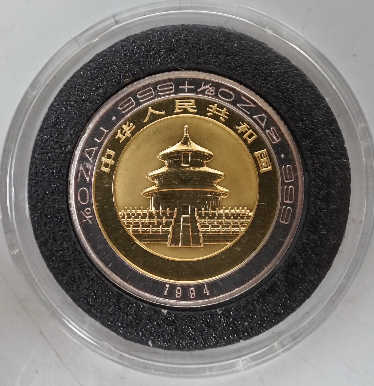 A Chinese Panda gold and silver 10 Yuan coin                                                                                                                                                                                