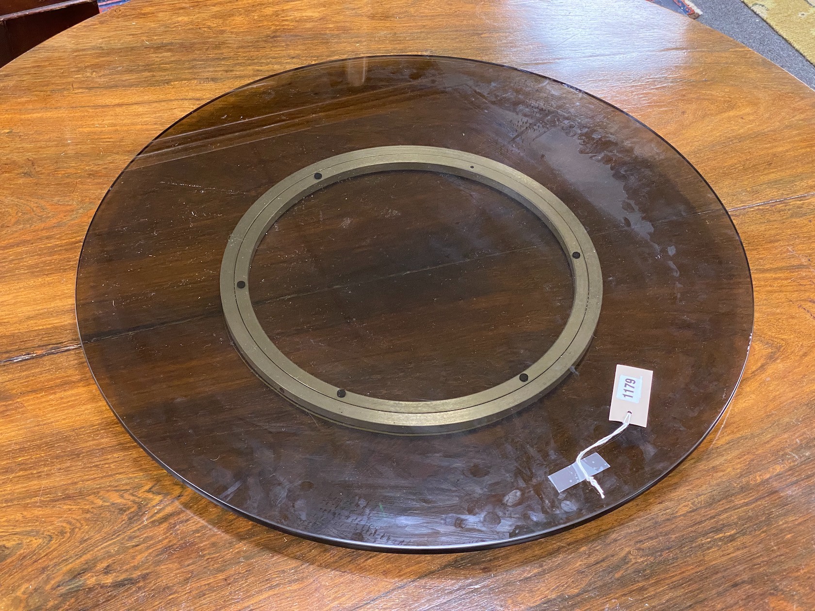 A contemporary smoked glass 'Lazy Susan', diameter 71cm                                                                                                                                                                     
