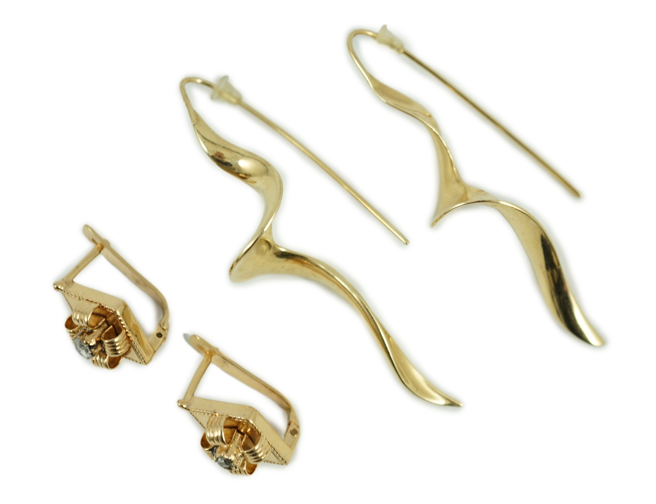 A modern pair of 14k spiral earrings, 50mm, 6.4 grams and a part of yellow metal and solitaire rose cut diamond set earrings, gross 4.2 grams.                                                                              
