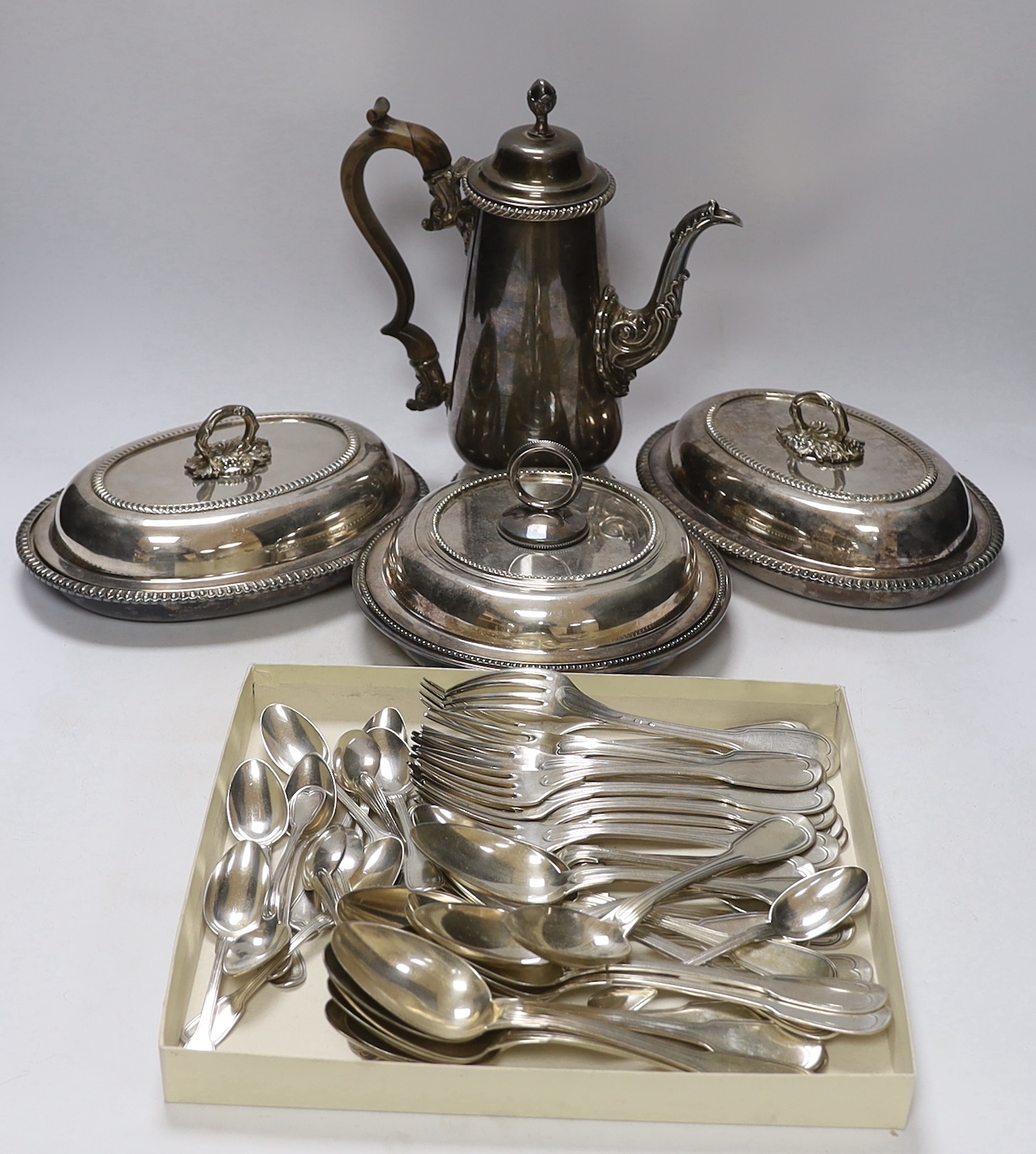 Assorted plated wares including Christofle flatware, coffee pot and three serving dishes.                                                                                                                                   