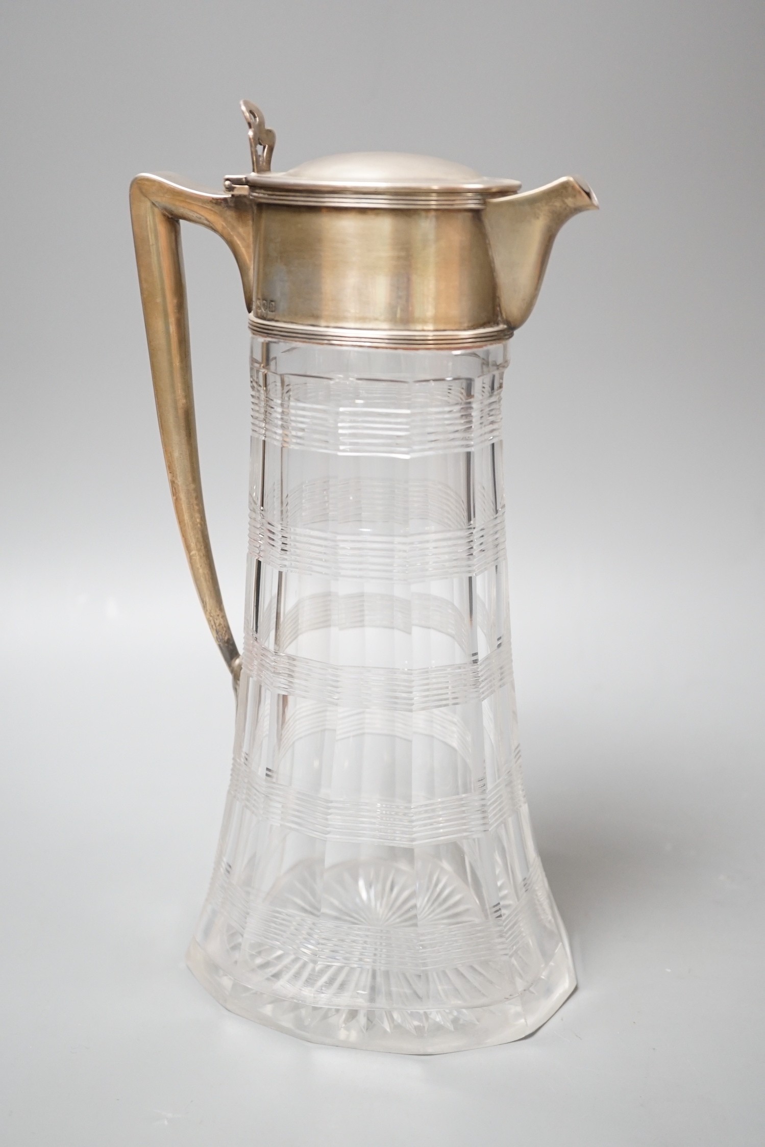 A late Victorian silver mounted cut glass claret jug, with reeded bands, John Grinsell & Sons, London, 1900, 26.5cm.                                                                                                        