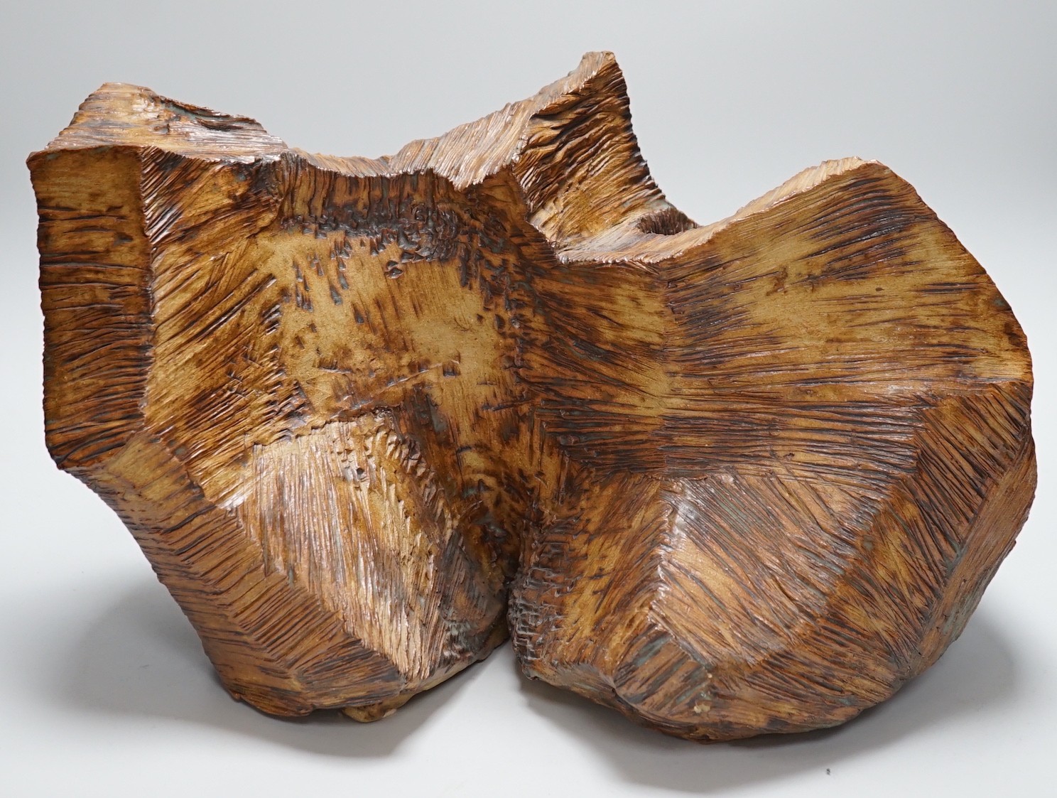 Ruth Sulke - a studio pottery copper-glaze abstract sculpture of a simulated hewn and chisled log, 43cms wide x 28.5 high                                                                                                   