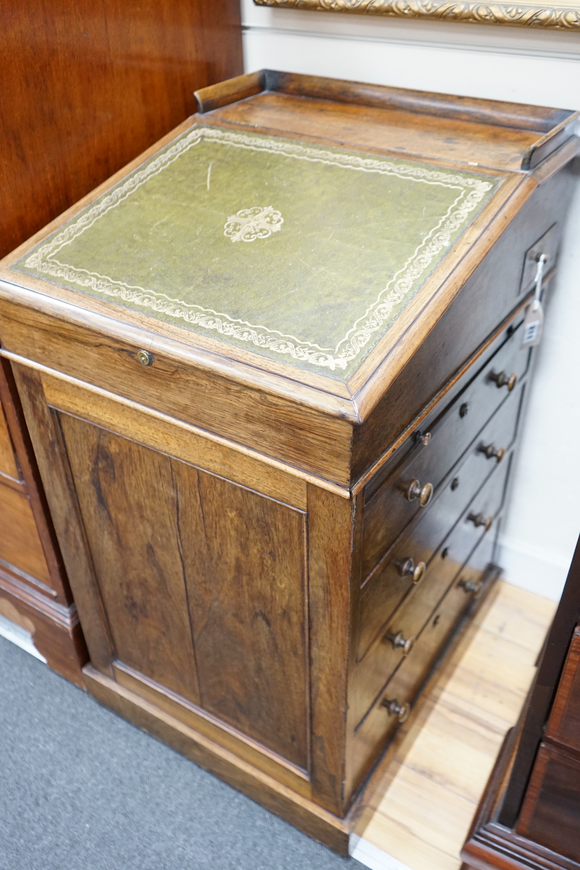 An early Victorian rosewood Davenport, with sliding top, width 50cm, depth 58cm, height 89cm                                                                                                                                