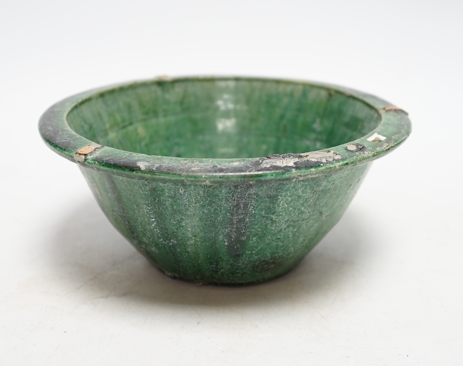 A Chinese green glazed bowl, Yuan-Ming dynasty, 19cm diameter                                                                                                                                                               