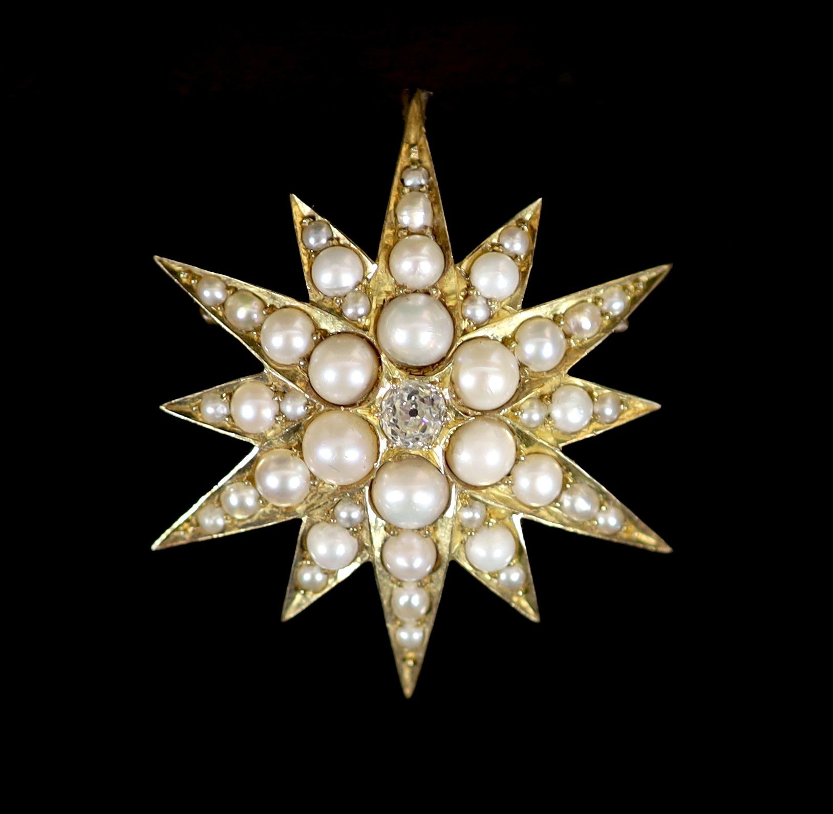 A Victorian gold, split pearl and diamond starburst pendant brooch                                                                                                                                                          