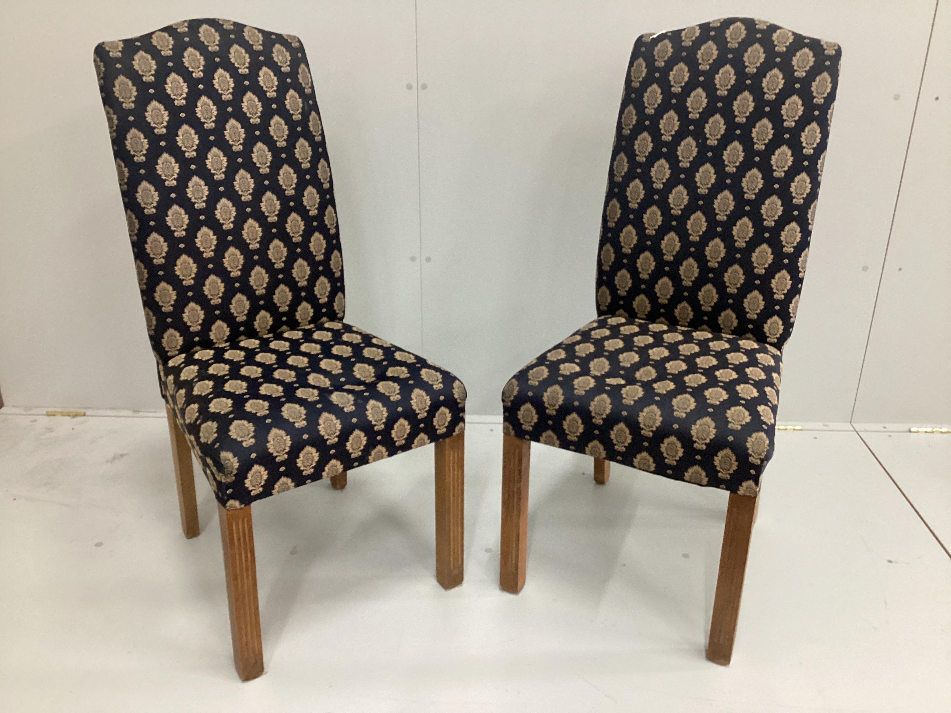 A set of eight George III style upholstered high back dining chairs on fluted square beech legs                                                                                                                             