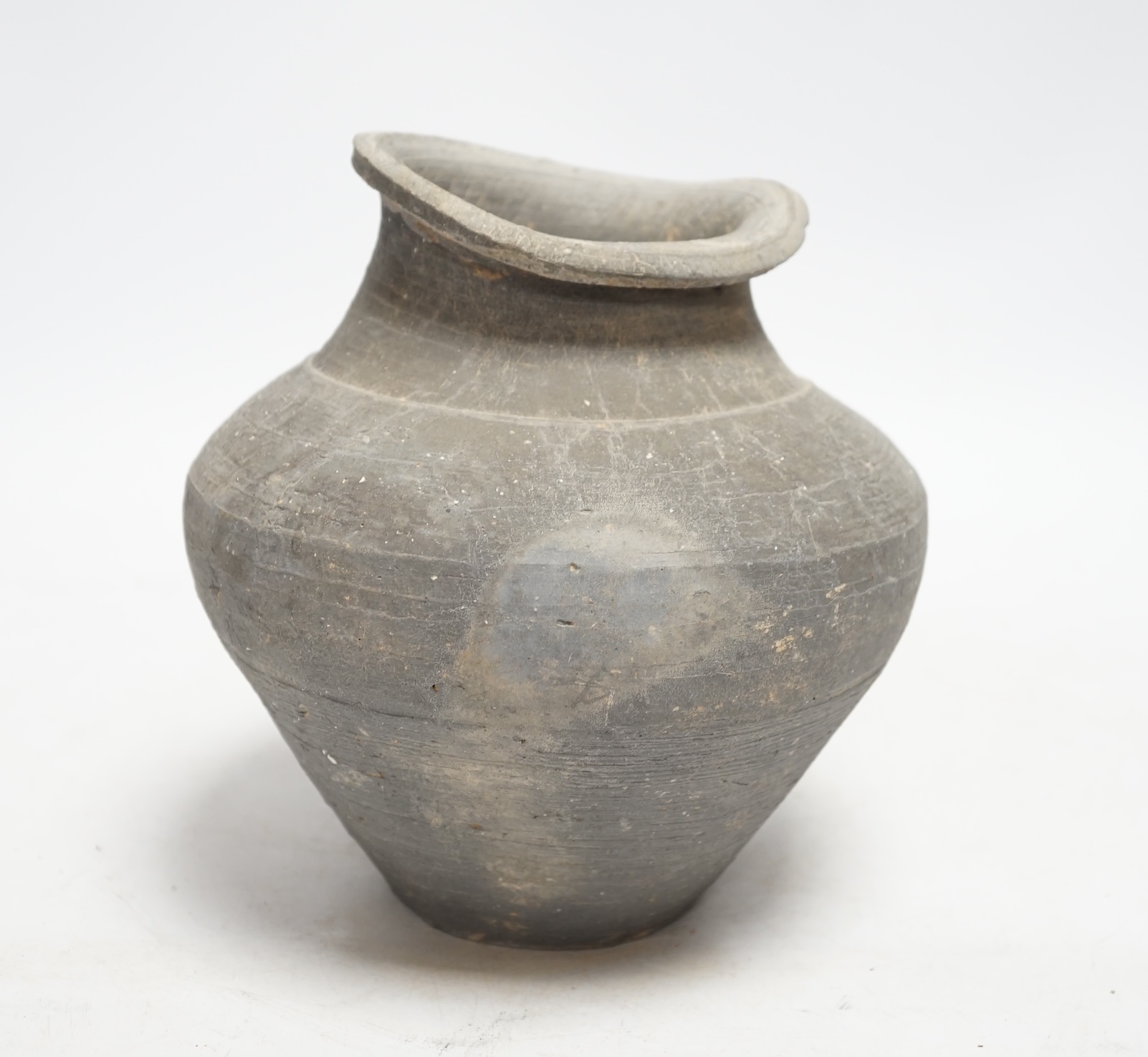 A Chinese grey pottery ribbed jar, probably Han dynasty, 19cm high                                                                                                                                                          